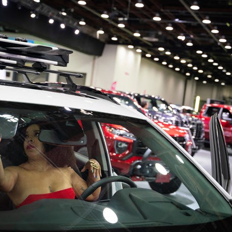 Detroit resident Cleo Anderson sits inside of a 2023 GMC Terrain AT4 during the 2023 North American International Auto Show Charity Preview at Huntington Place in Detroit on Friday, September 15, 2023.