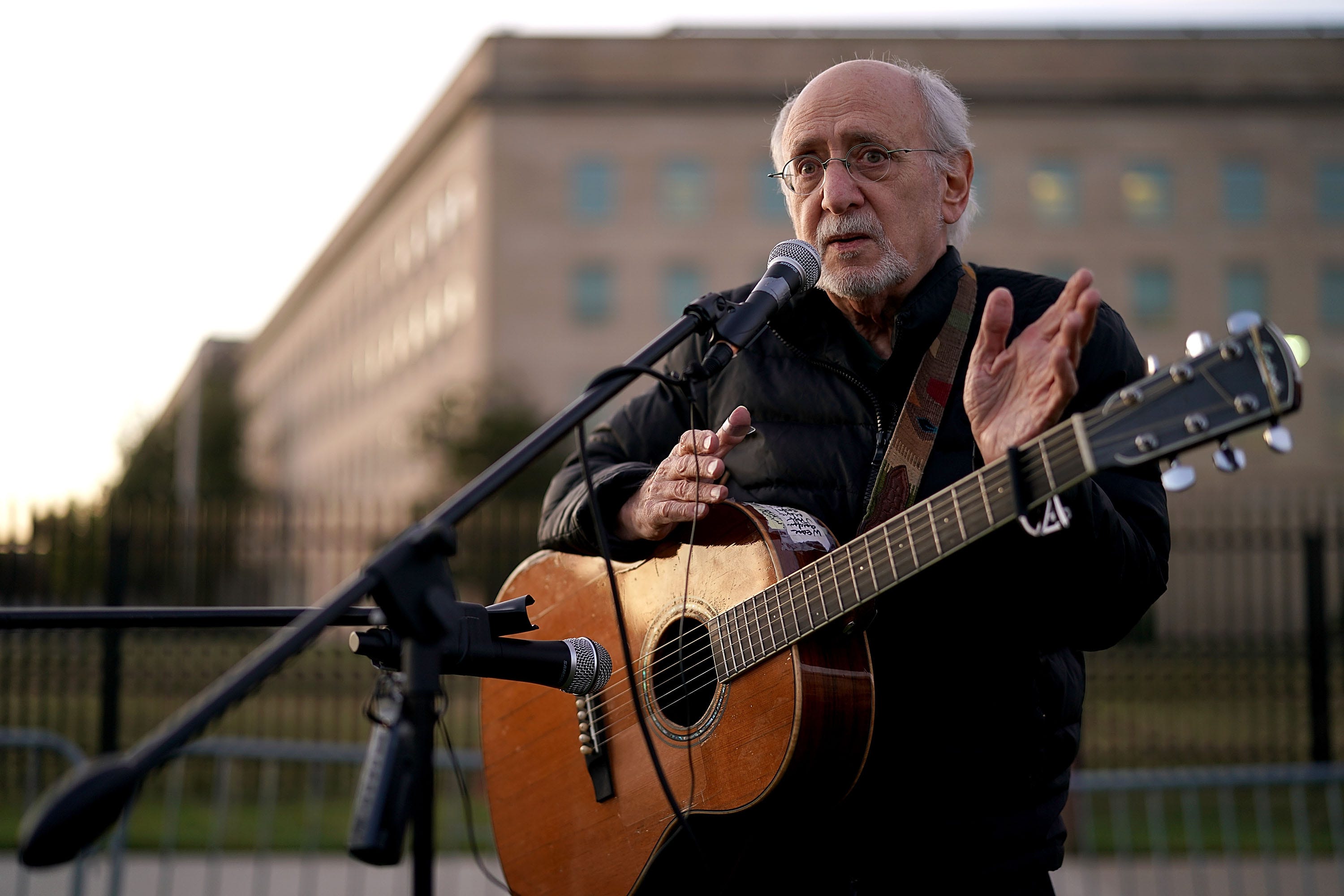 Peter Yarrow, founding member of the legendary folk group Peter, Paul and Mary, sings and speaks about the 1967 March on the Pentagon during a vigil marking the 50th anniversary of the protest outside the Pentagon Oct. 20, 2017, in Arlington, Virginia.