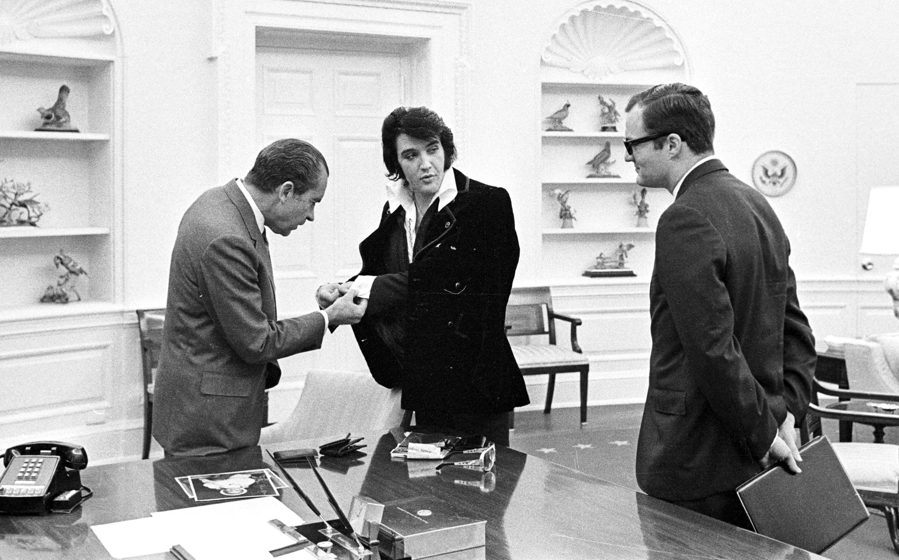 Elvis Presley shows President Richard Nixon his cuff links Dec. 21, 1970 at the White House.
