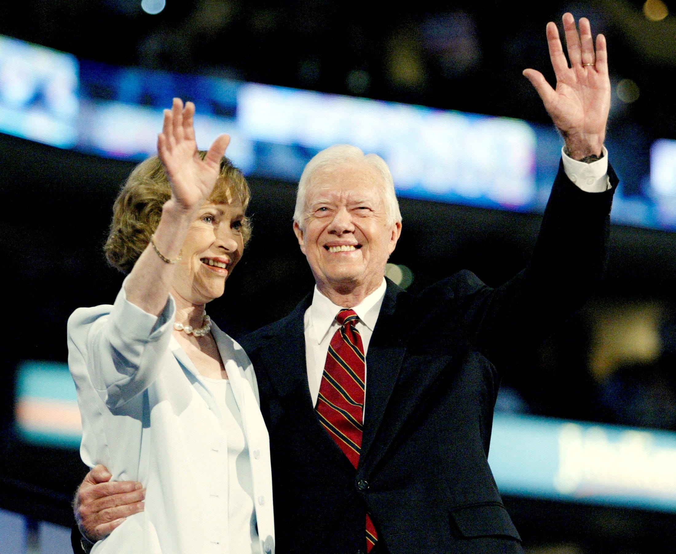 Former U.S. President Jimmy Carter and his wife Rosalynn Carter wave to the crowd after Jimmy Carter's speech before the 2004 Democratic National Convention, at the FleetCenter in Boston, Massachusetts, U.S. July 26, 2004. REUTERS/Brian Snyder/File Photo