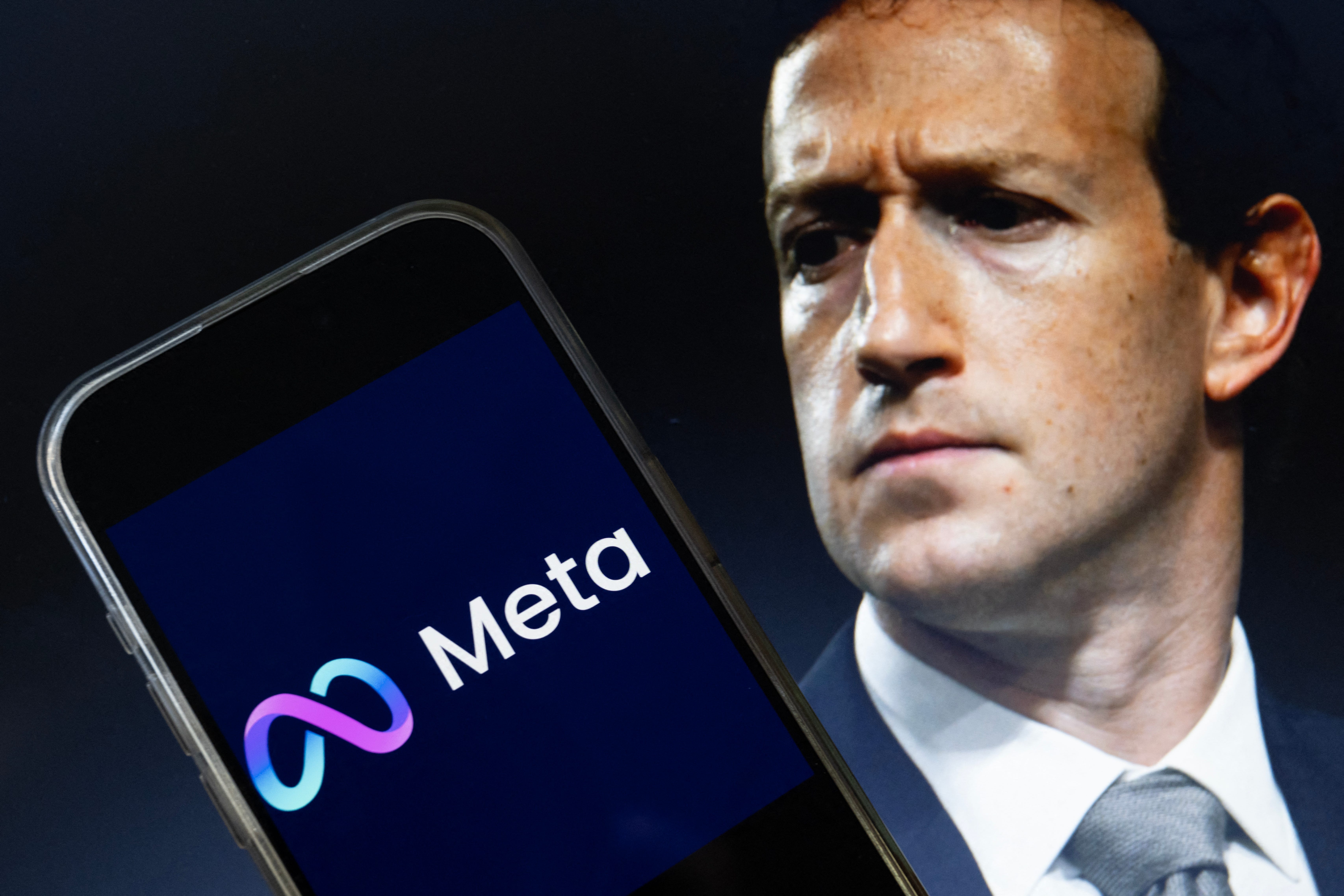 This photo illustration shows an image of Meta CEO Mark Zuckerberg and a phone displaying the download page for the Facebook app.
