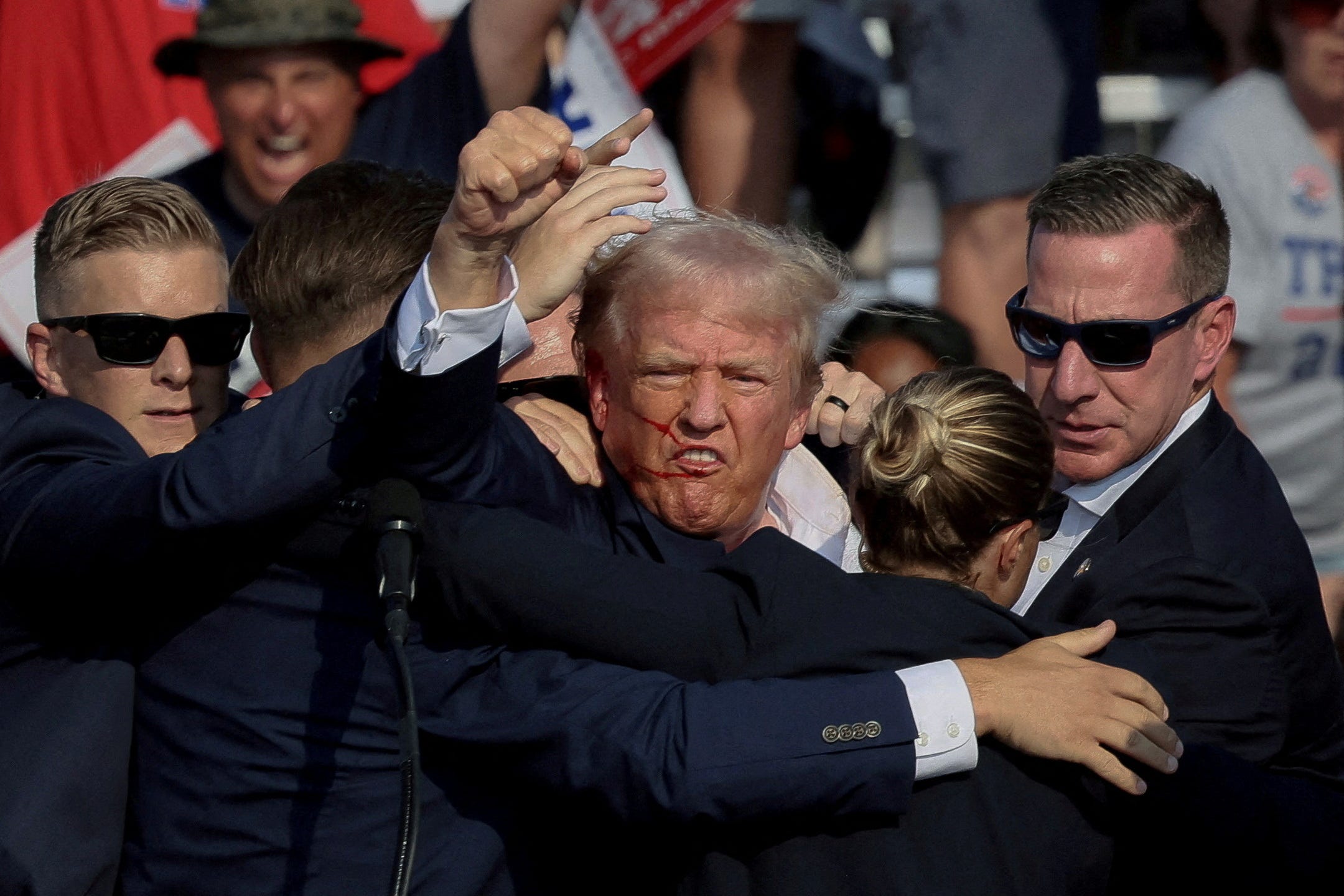 FILE PHOTO: Republican presidential candidate and former U.S. President Donald Trump is assisted by the Secret Service after gunfire rang out during a campaign rally at the Butler Farm Show in Butler, Pennsylvania, U.S., July 13, 2024.