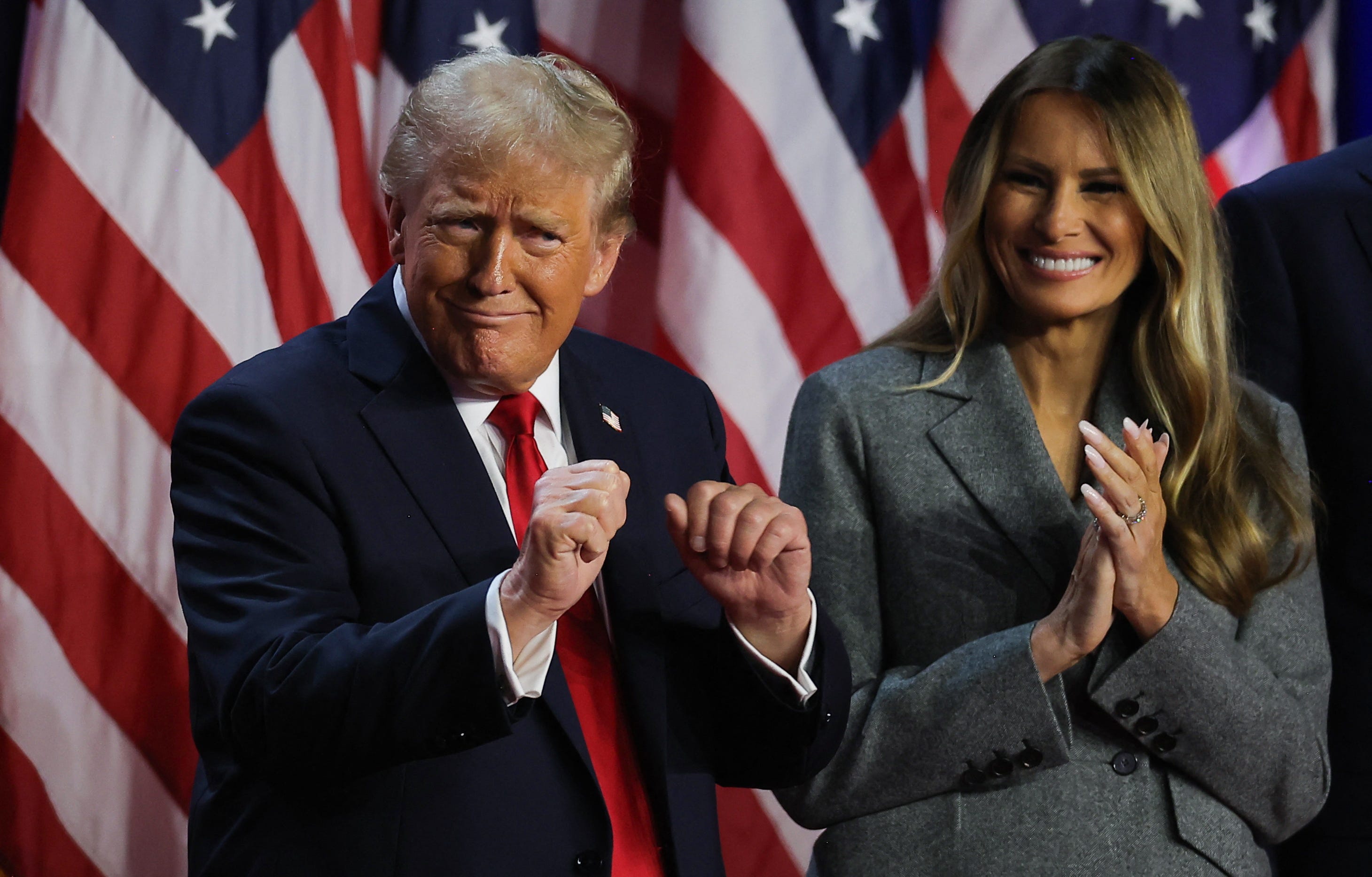 Republican presidential nominee Donald Trump and his wife, Melania Trump, cheer election results on Nov. 6, 2024, in West Palm Beach, Fla.