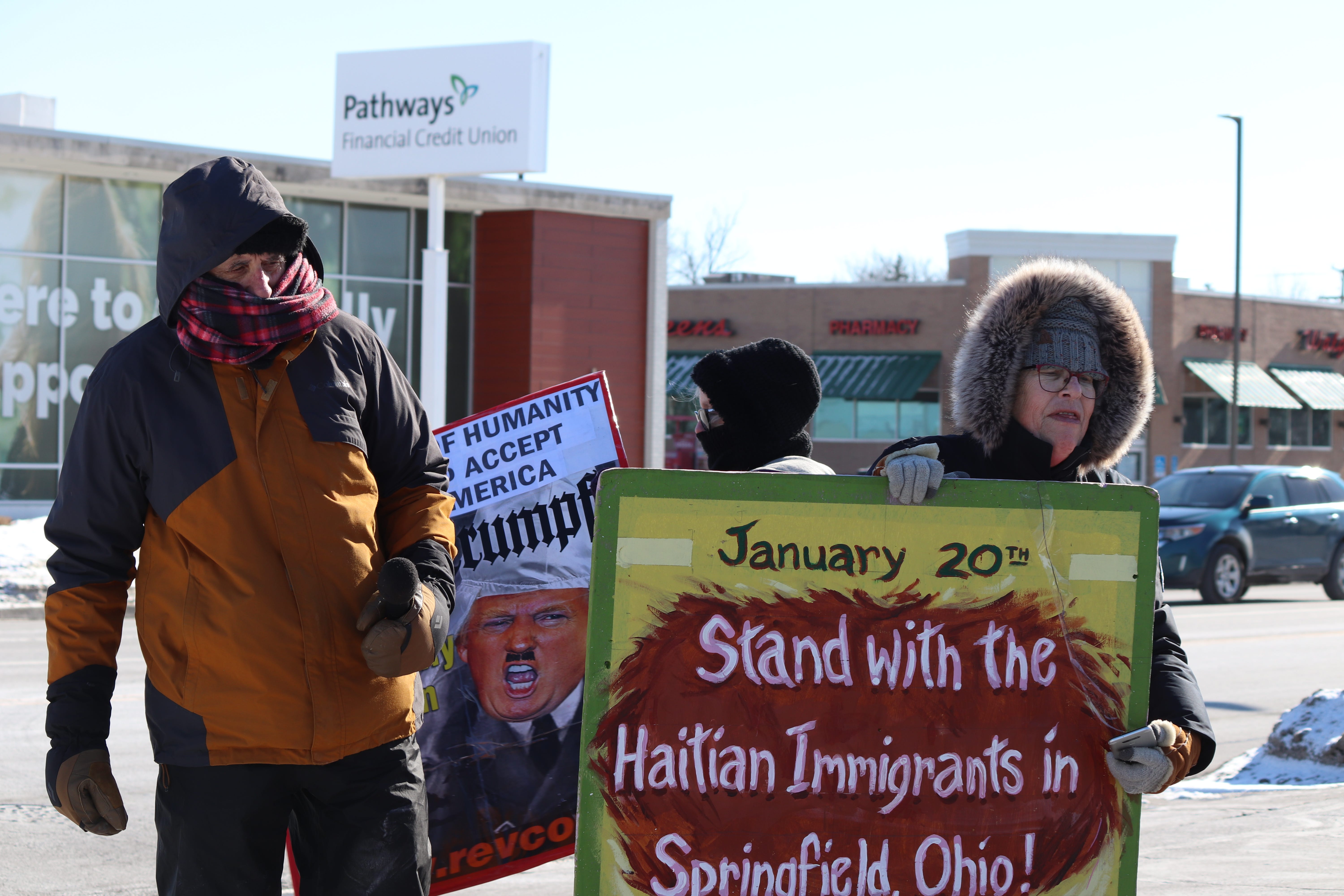 A small group of protestors from the Revcom Corps show support for Haitian immigrants in Springfield on President Donald Trump's inauguration day.