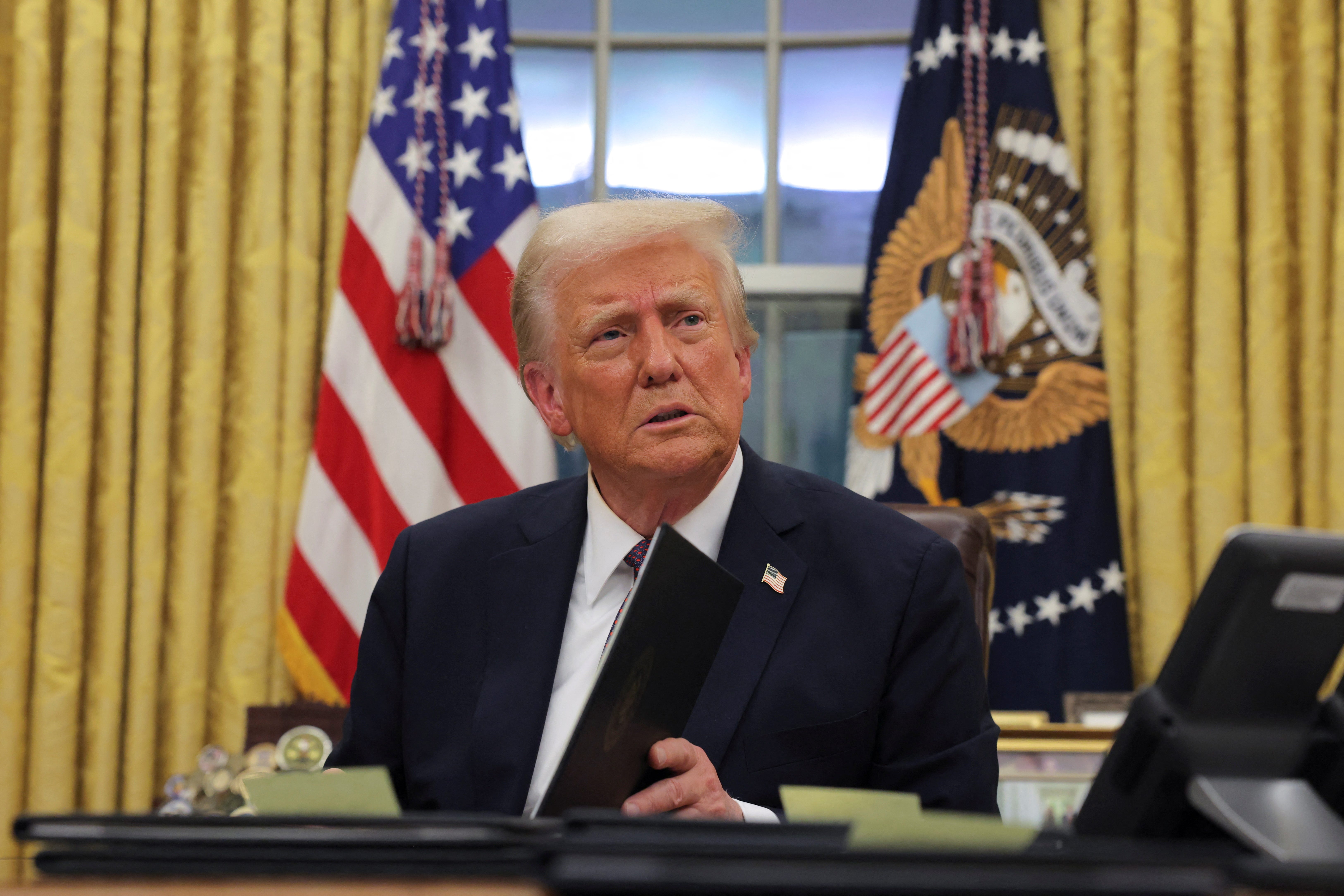 U.S. President Donald Trump signs executive orders for January 6 defendants in the Oval Office at the White House on Inauguration Day in Washington, D.C. on Jan. 20, 2025.