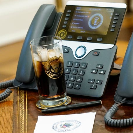 President Donald Trump's glass of Diet Coke with the presidential seal on it in the Oval Office at the White House in 2018. Diet Coke is mainly sweetened with the artificial sweetener aspartame.