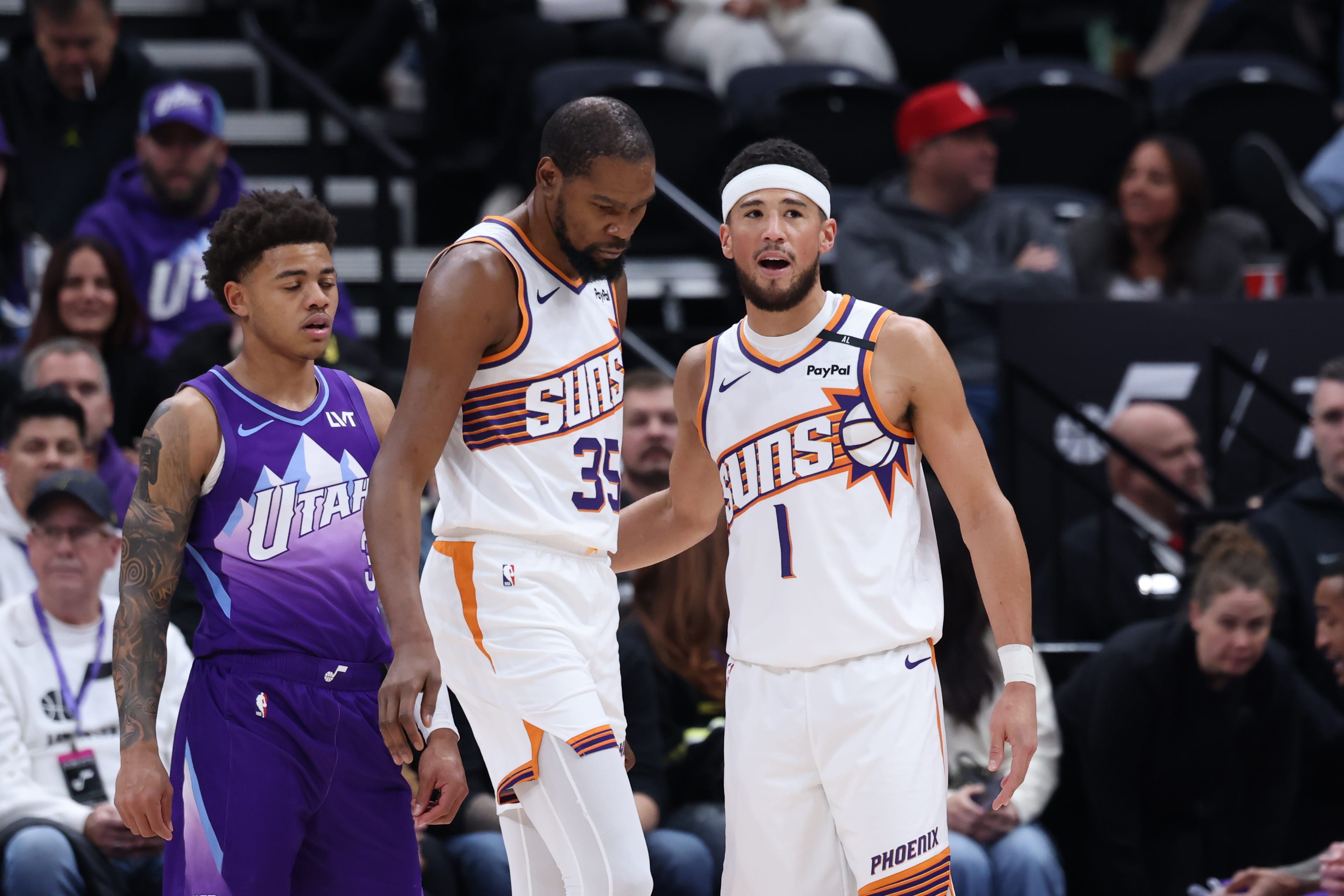 Phoenix Suns forward Kevin Durant (35) and guard Devin Booker (1) speak after a play against the Utah Jazz during a game on Dec. 13, 2024.