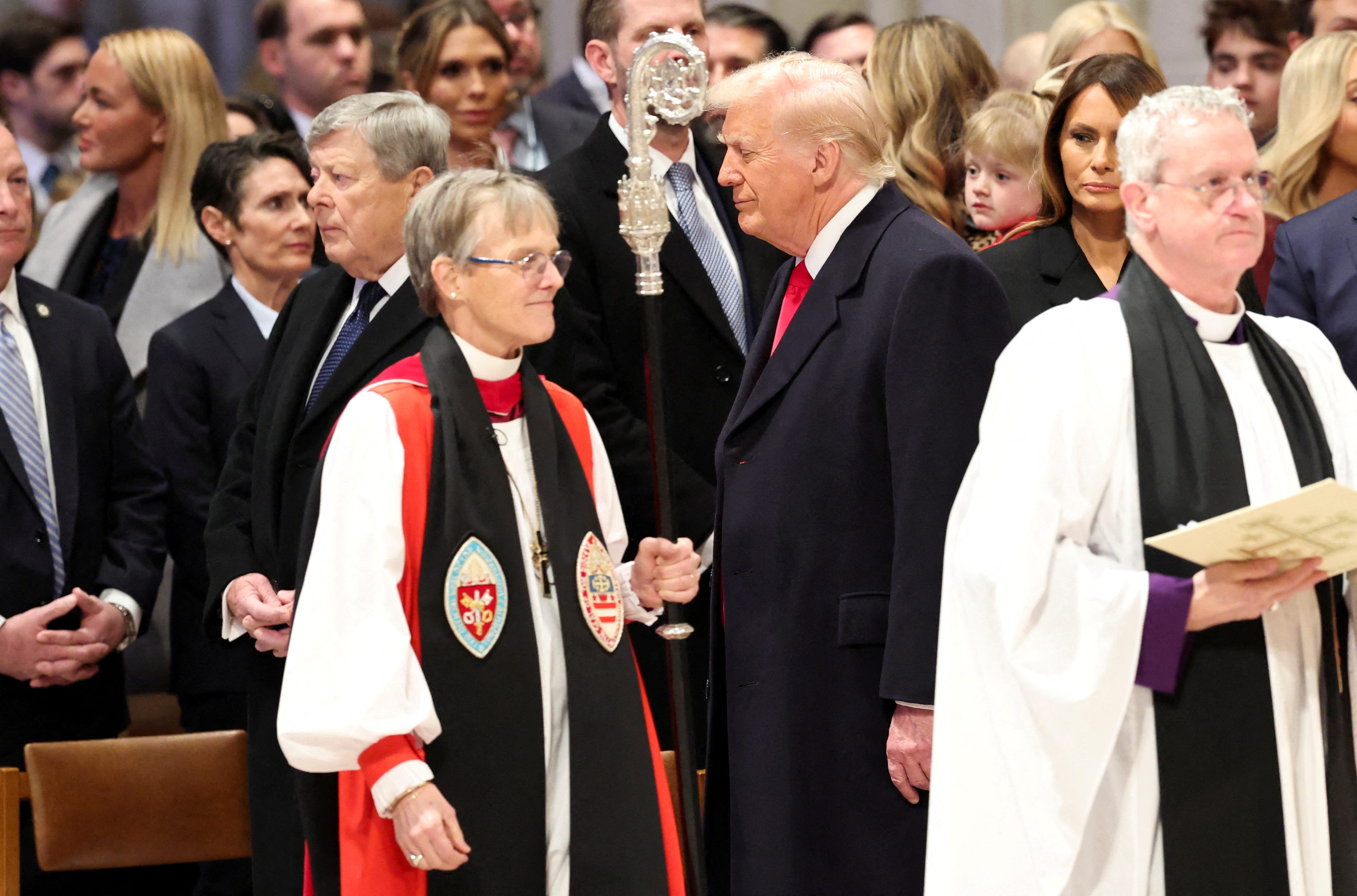 President Donald Trump and attendees of the National Day of Prayer Service stand as the Rev. Mariann Edgar Budde, the Episcopal bishop of Washington, D.C., enters on Jan. 21, 2025.