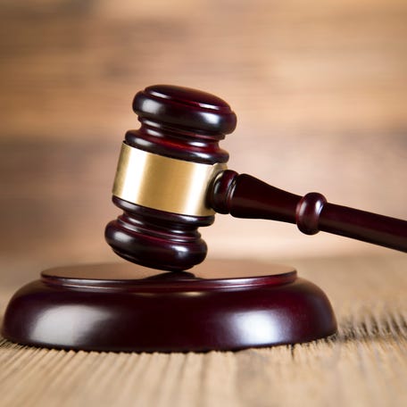 Final speech, notebook, Lady of justice, gavel and books on wood