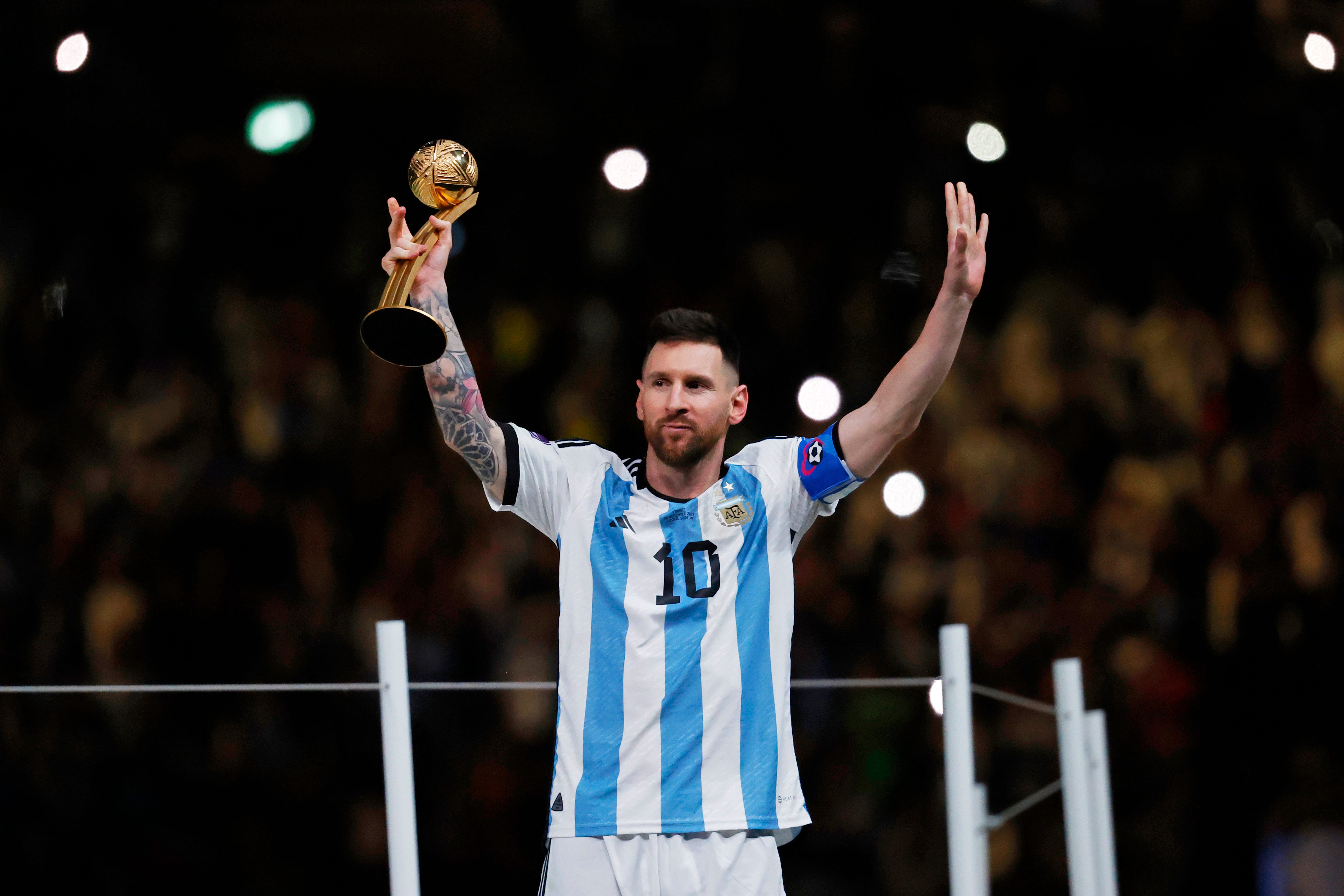 Argentina forward Lionel Messi (10) holds the golden ball trophy after winning the 2022 World Cup final against France at Lusail Stadium.