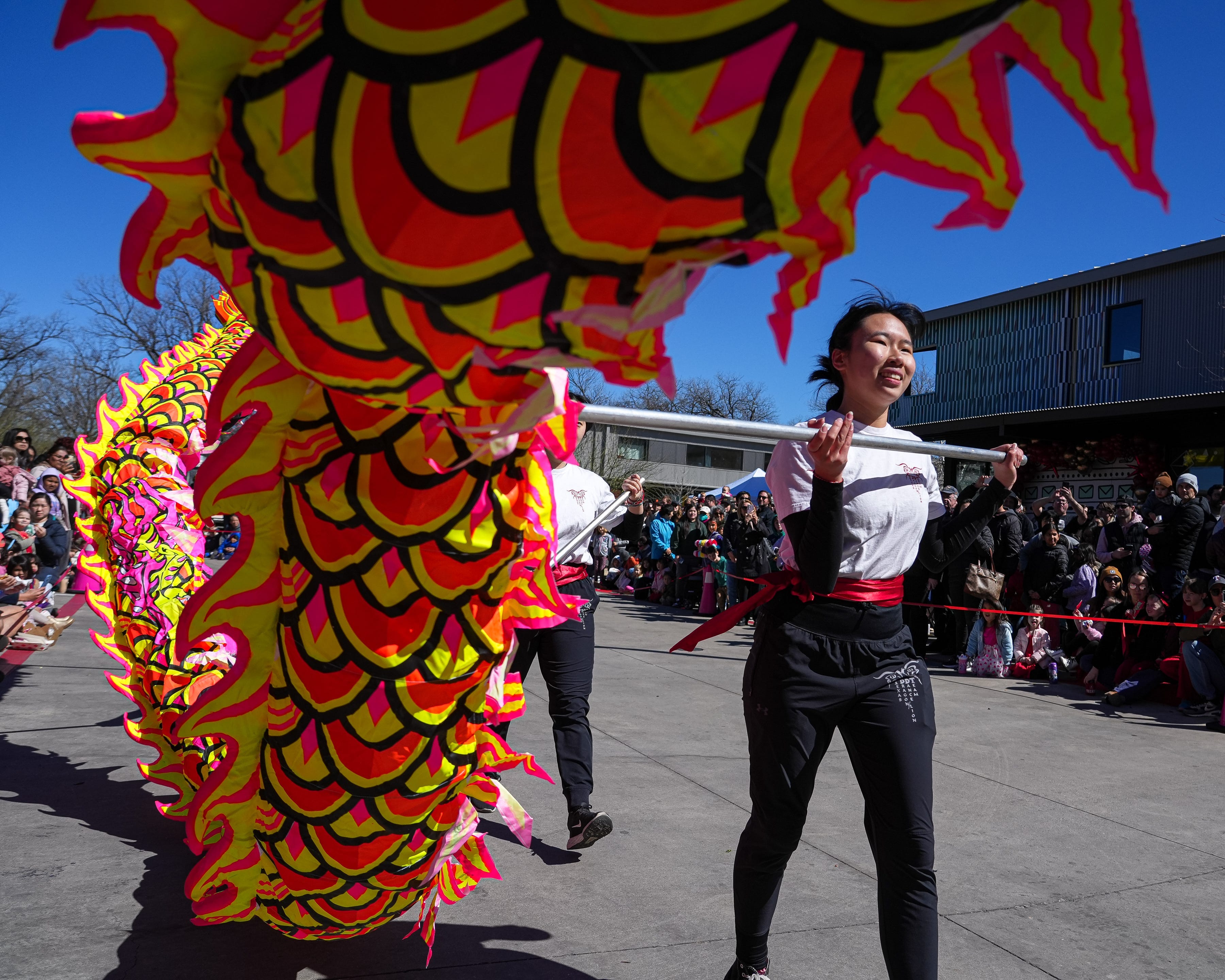 A woman carries a section of a dragon in February 2024 during a Chinese dragon dance at a Lunar New Year Festival in Austin, Texas.