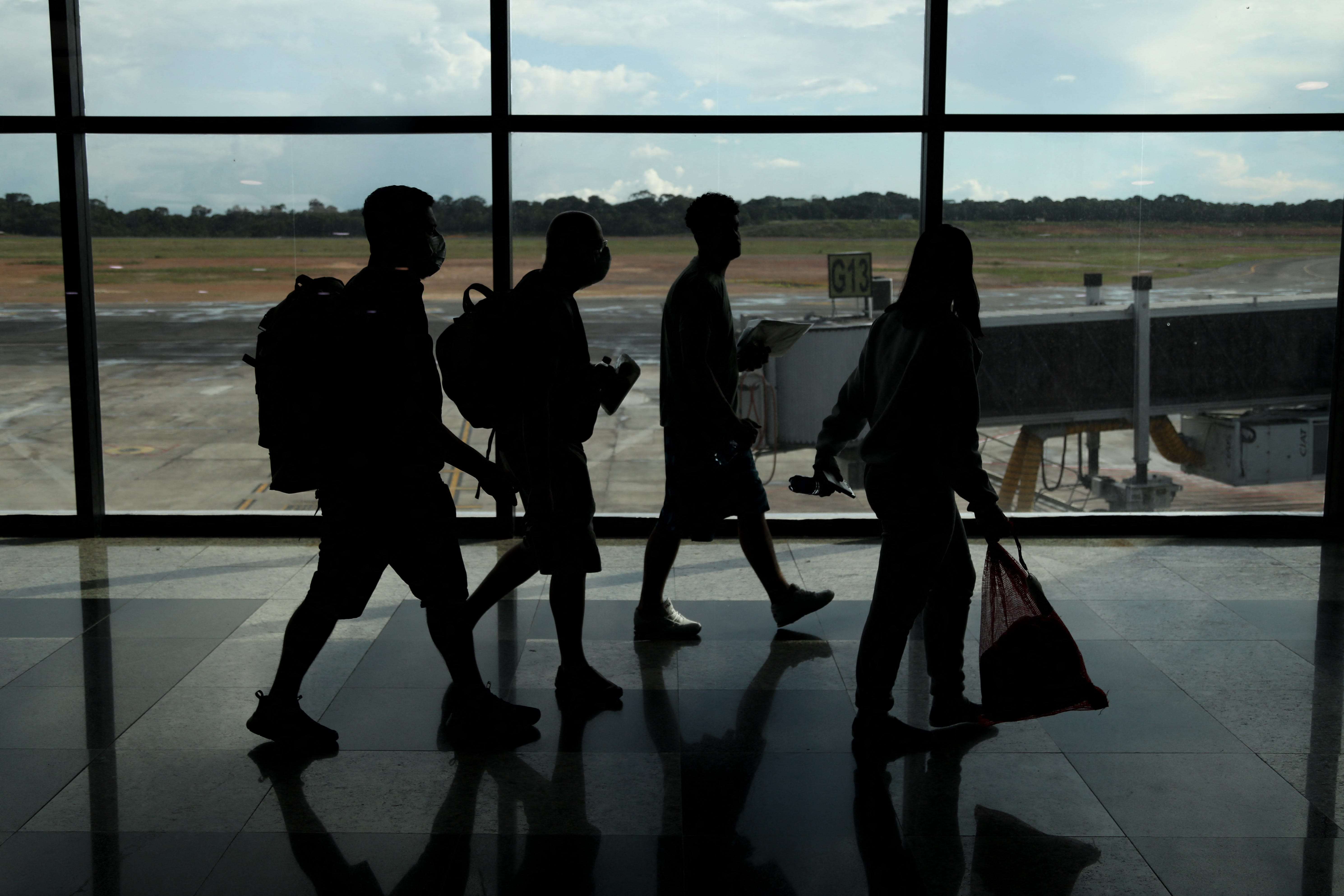 Brazilians who were deported from the United States walk through the departure lounge at Eduardo Gomes International Airport in Manaus, Amazonas state, Brazil on Jan. 25, 2025. Brazil condemned the "disregard for fundamental rights" of nearly 80 Brazilian illegal migrants deported from the U.S. who were handcuffed during the journey. The plane landed in Manaus due to technical problems.