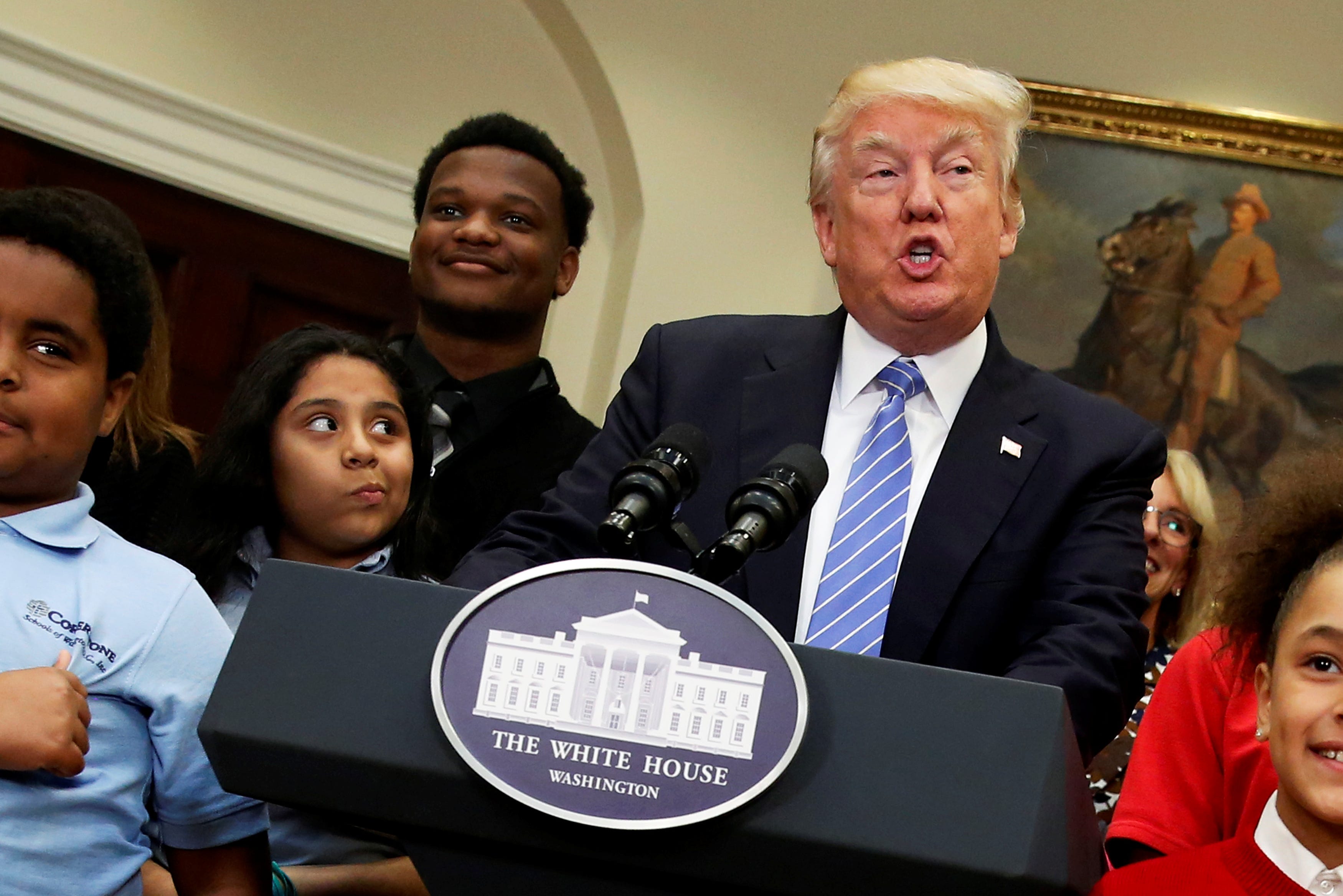 U.S. President Donald Trump is surrounded by local schoolchildren as he delivers remarks at a school choice event at the White House in Washington, U.S. May 3, 2017.