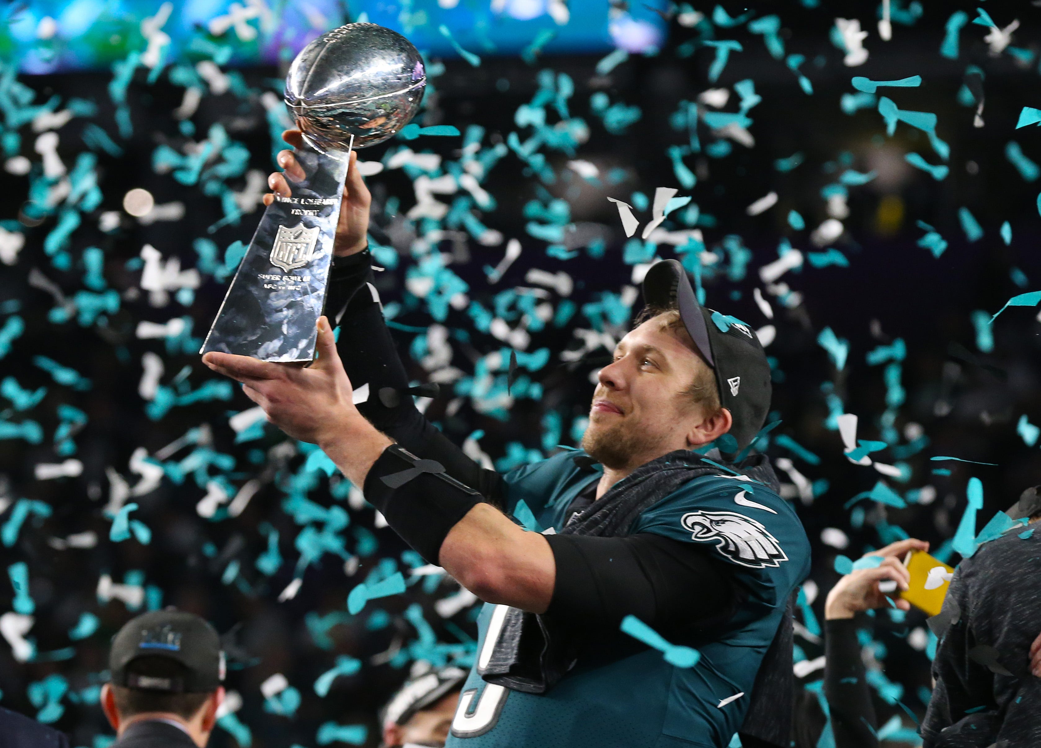 Philadelphia Eagles quarterback Nick Foles hoists the Vince Lombardi Trophy after a Super Bowl victory against the New England Patriots at U.S. Bank Stadium in Minneapolis on Feb 4, 2018.