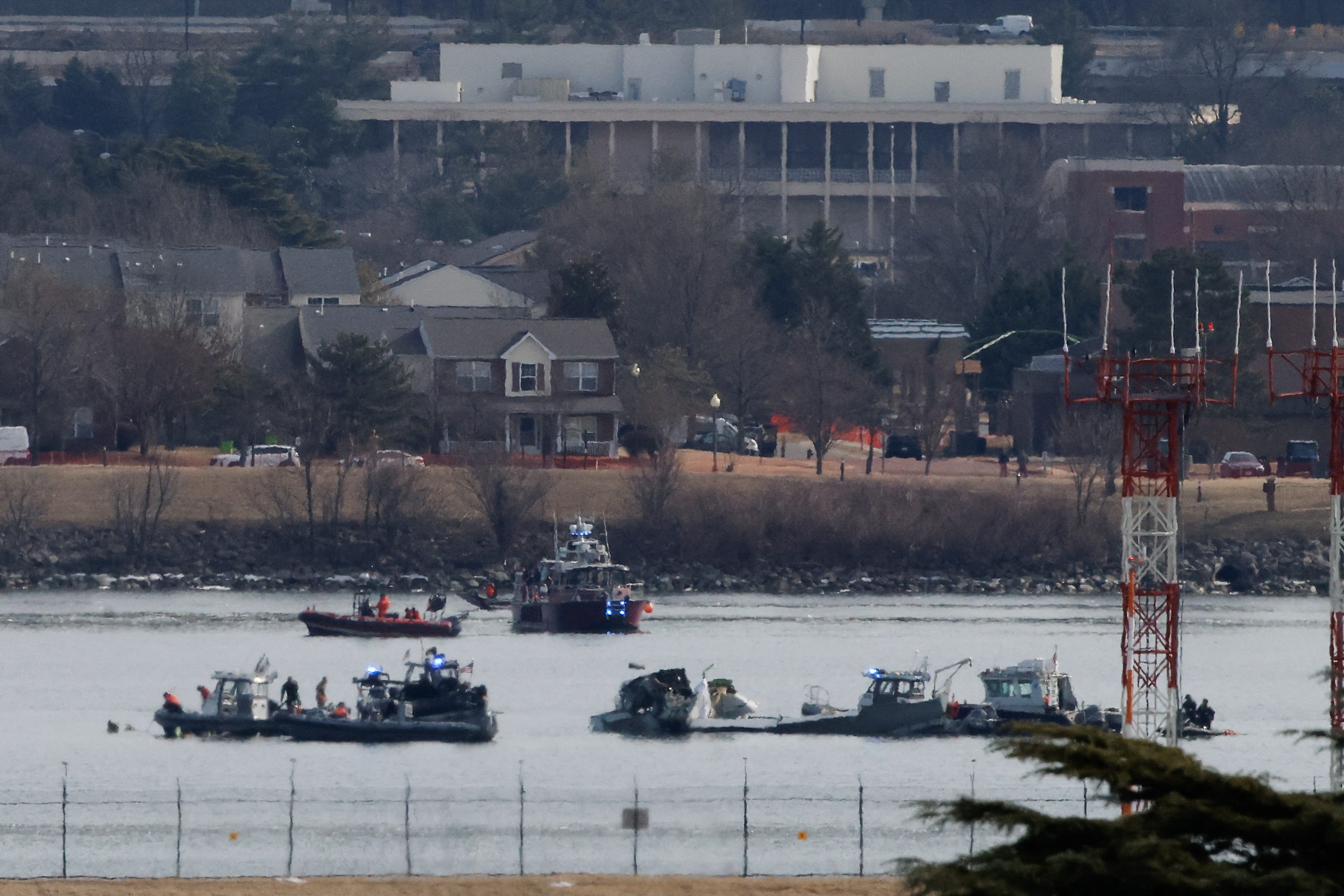Search and rescue teams work near the Ronald Reagan Washington National Airport, in the aftermath of the collision of American Eagle flight 5342 and a Black Hawk helicopter that crashed into the Potomac River, in Arlington, Virginia, U.S., January 30, 2025. REUTERS/Eduardo Munoz
