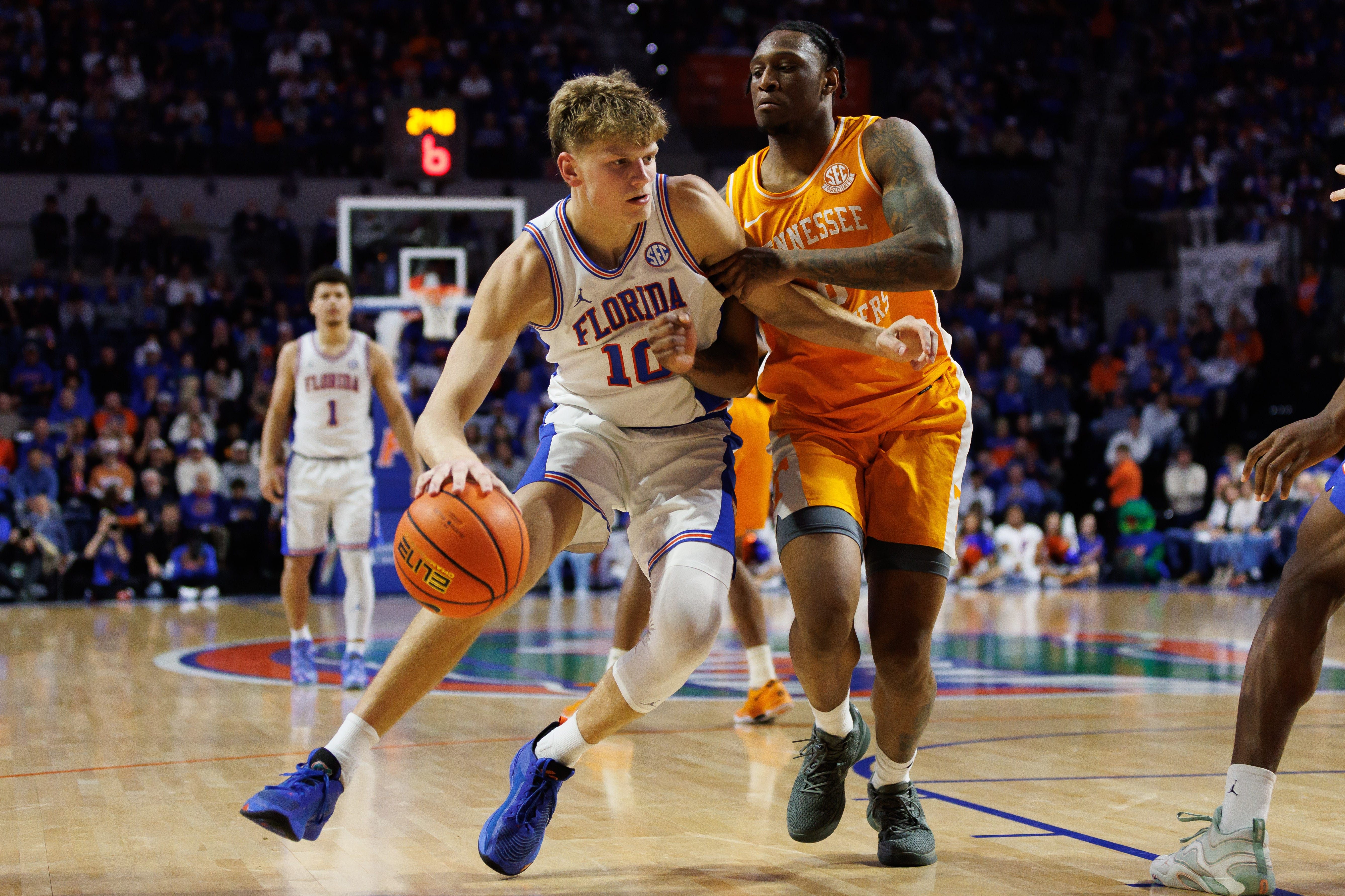 Florida forward Thomas Haugh (10) drives to the basket at Tennessee guard Darlinstone Dubar (8) during the second half at Exactech Arena at the Stephen C. O'Connell Center.