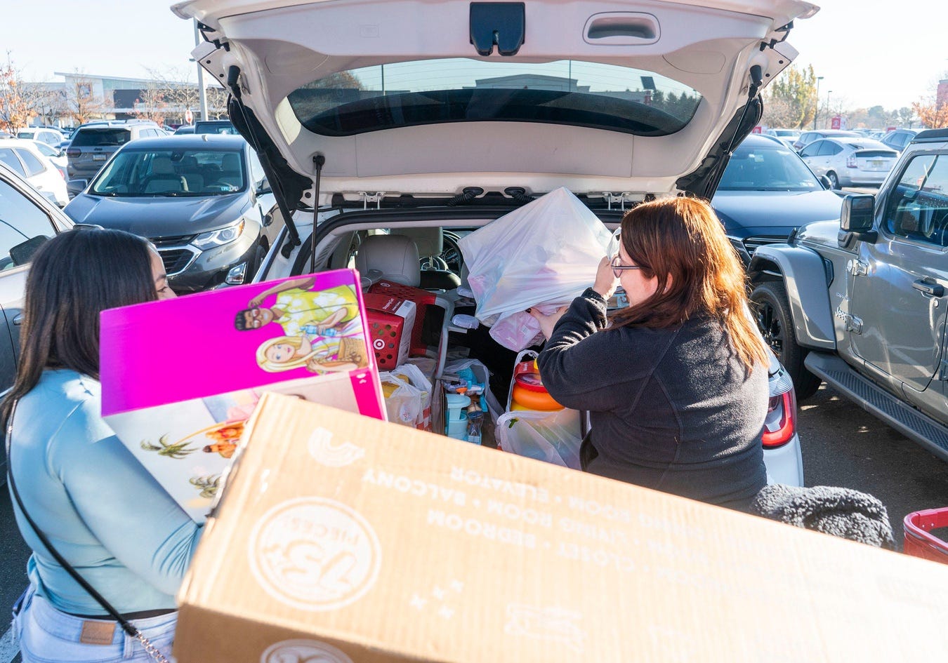 Nicole Concepcion, left, from Philadelphia, and Betzy Hernandez, right, from Levittown, pack up their car after holiday shopping at the Target in Langhorne on Friday, Nov. 29, 2024. Consumers said they were stressed about finances, but spent record numbers during the holidays.