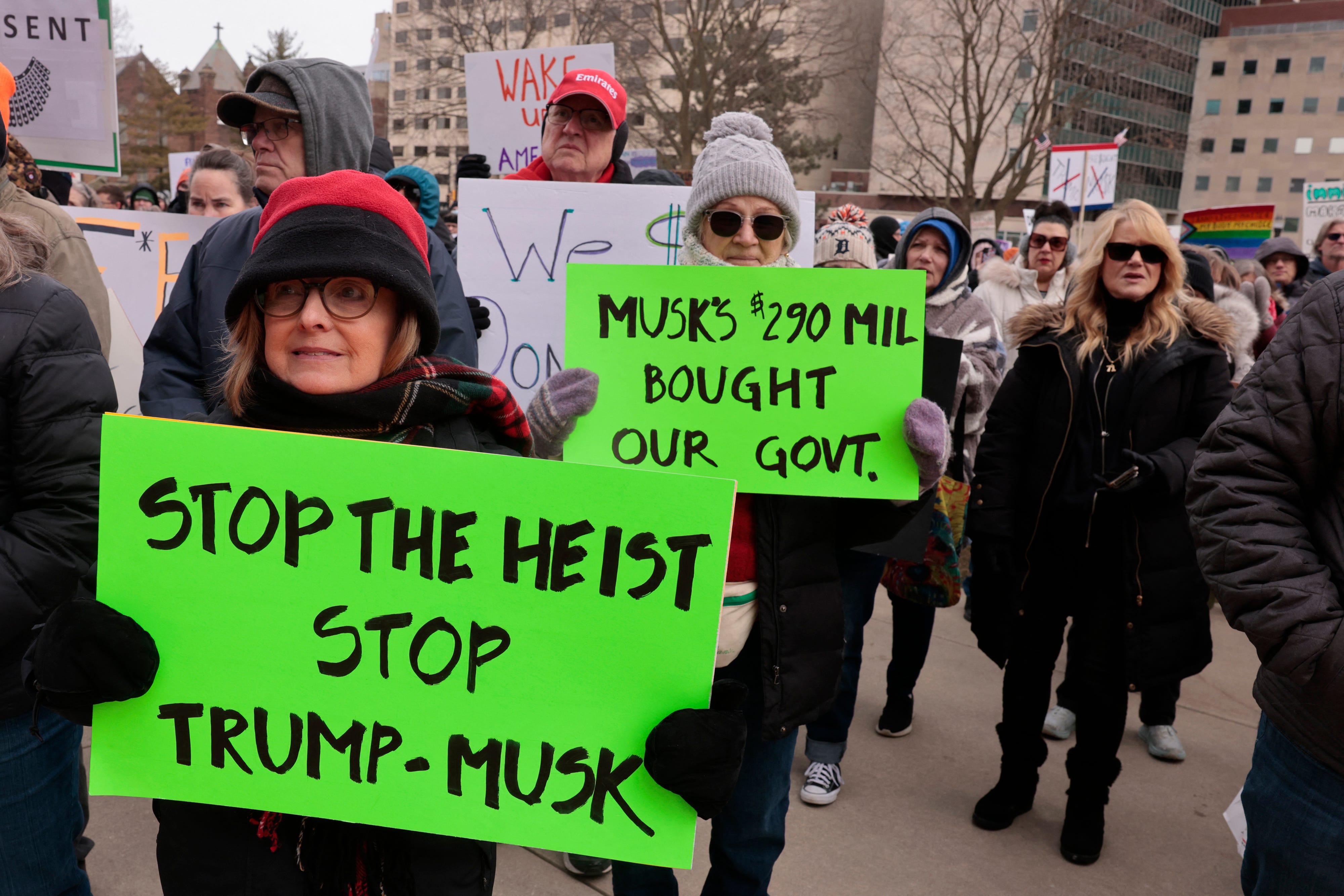 People protest against US President Donald Trump and Elon Musk outside the Michigan Capitol in Lansing, Michigan, on February 5, 2025.