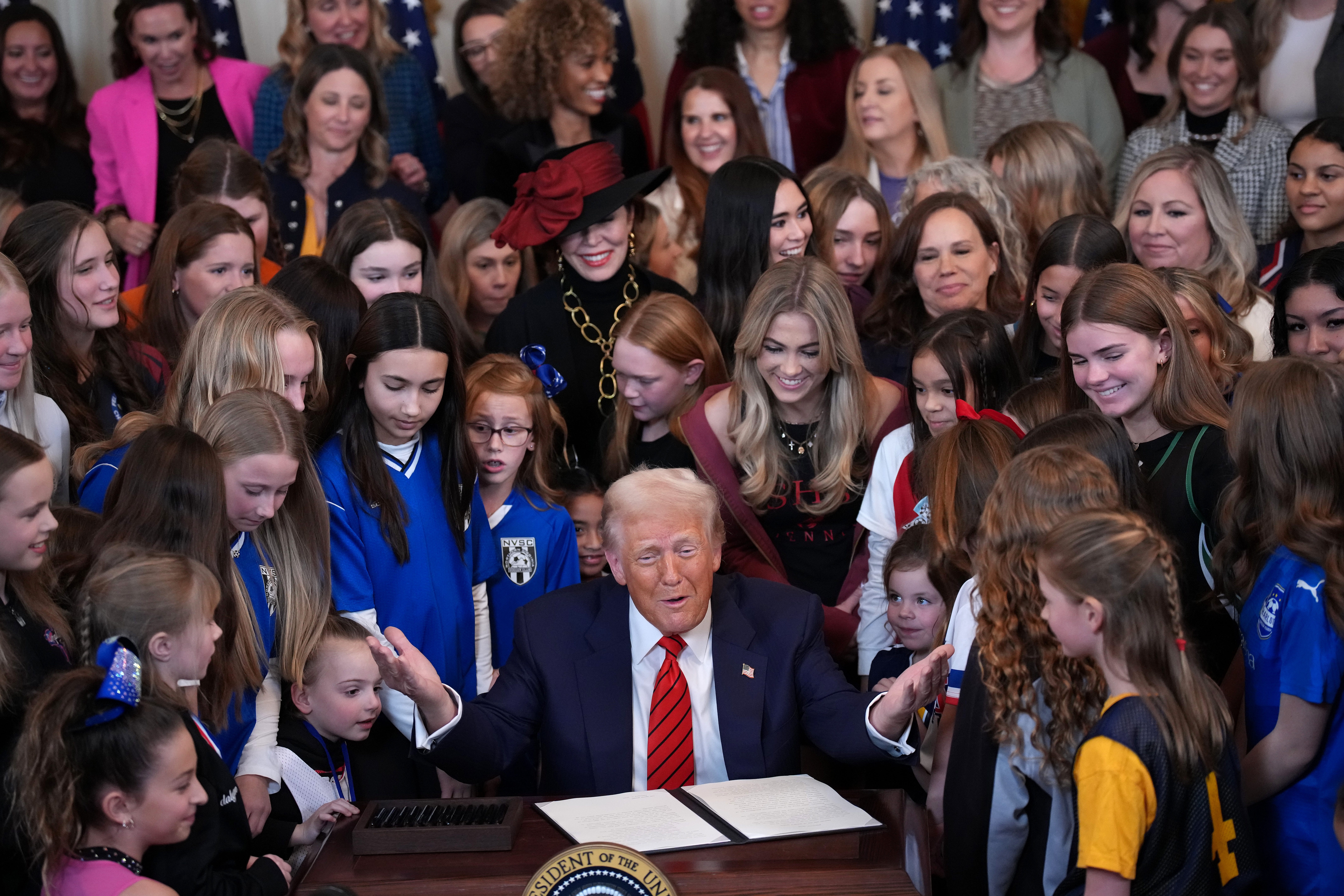 President Donald Trump joined by women athletes signs the No Men in Women's Sports executive order in the East Room at the White House on February 5, 2025 in Washington, DC.
