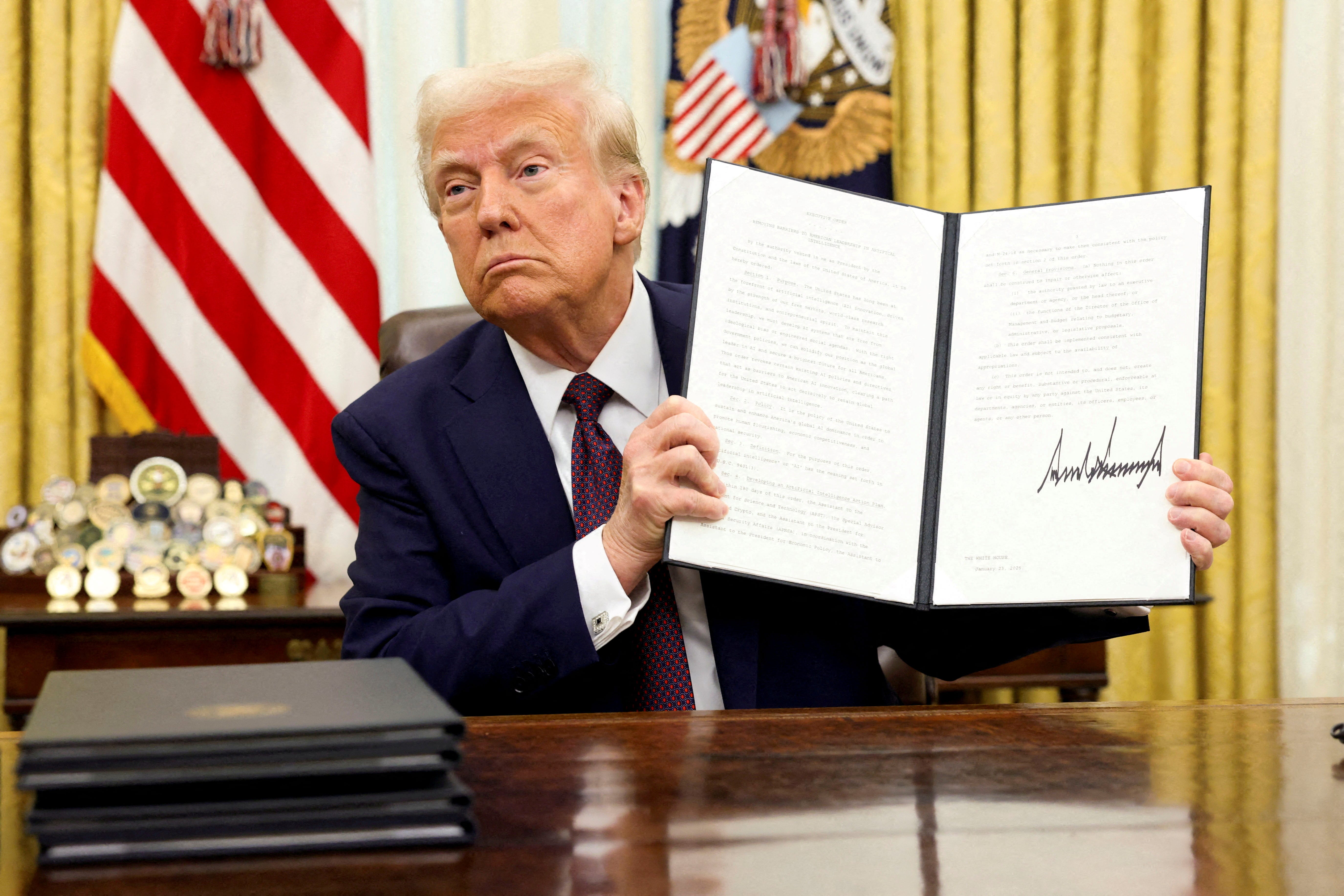 President Donald Trump holds a signed executive order on AI, in the Oval Office of the White House, in Washington, on Jan. 23, 2025.