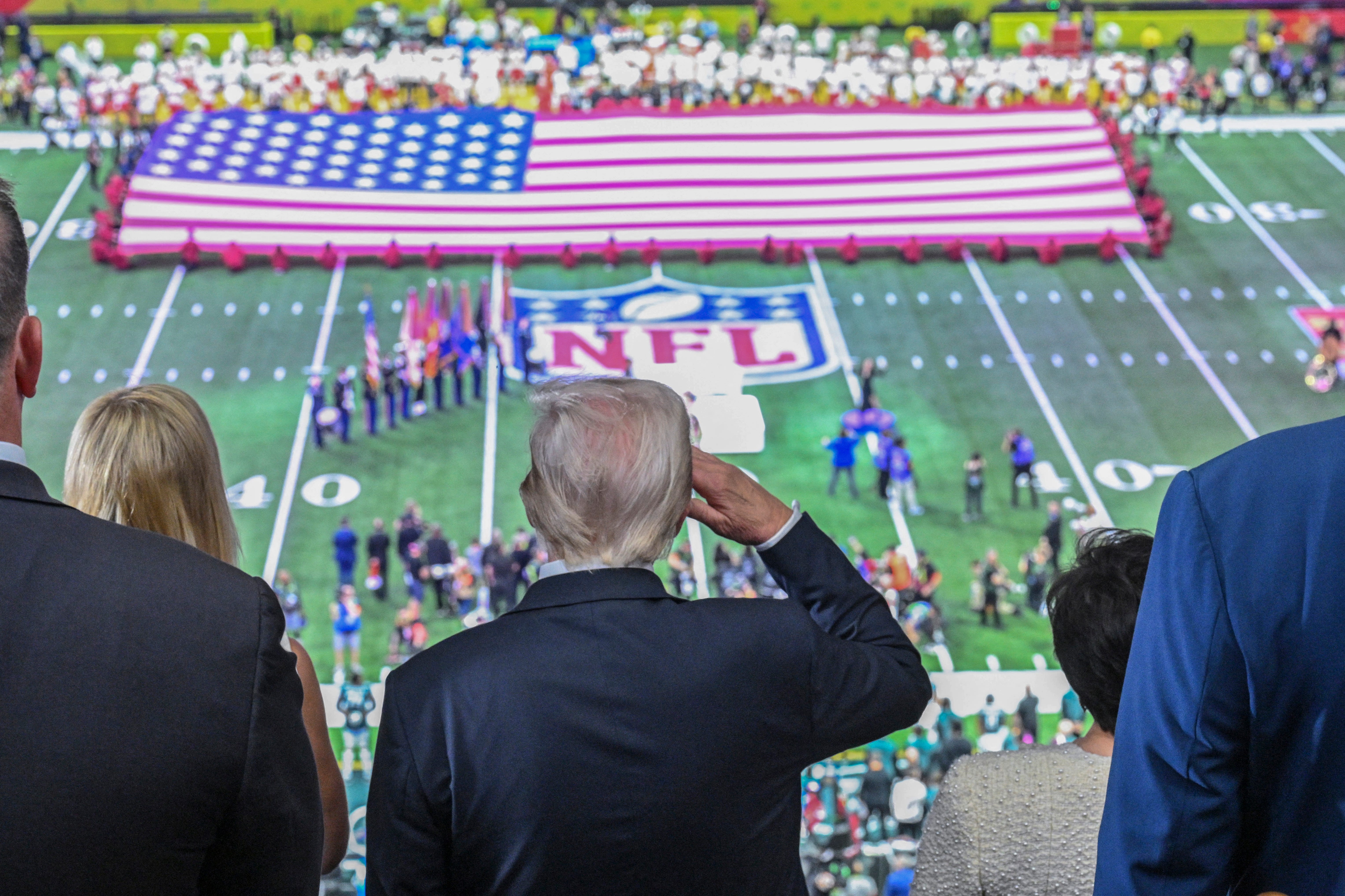 TOPSHOT - US President Donald Trump salutes as the national anthem is played before the start of Super Bowl LIX between the Kansas City Chiefs and the Philadelphia Eagles at Caesars Superdome in New Orleans, Louisiana, February 9, 2025.