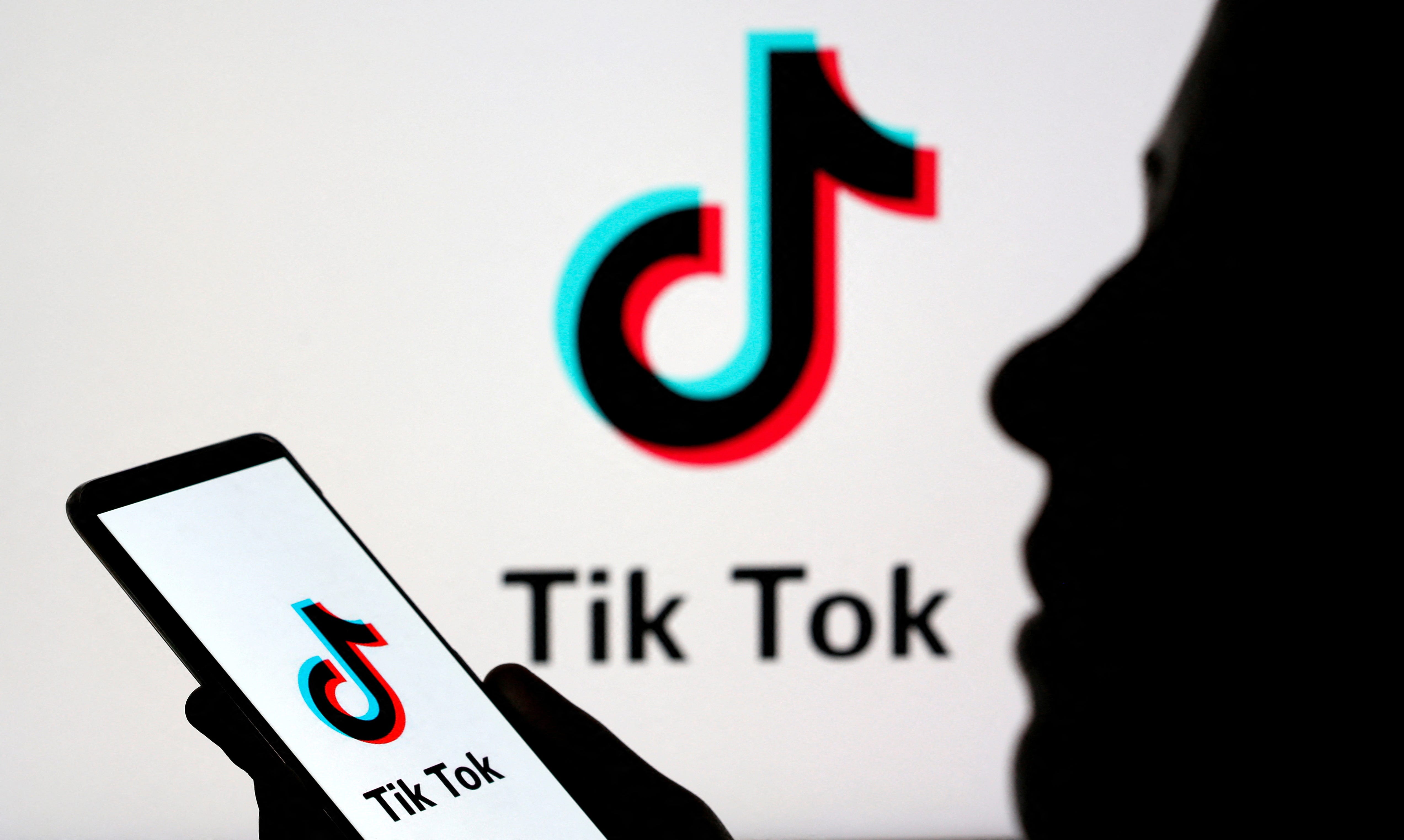 FILE PHOTO: A person holds a smartphone with Tik Tok logo displayed in this picture illustration taken November 7, 2019. Picture taken November 7, 2019. REUTERS/Dado Ruvic/Illustration/File Photo