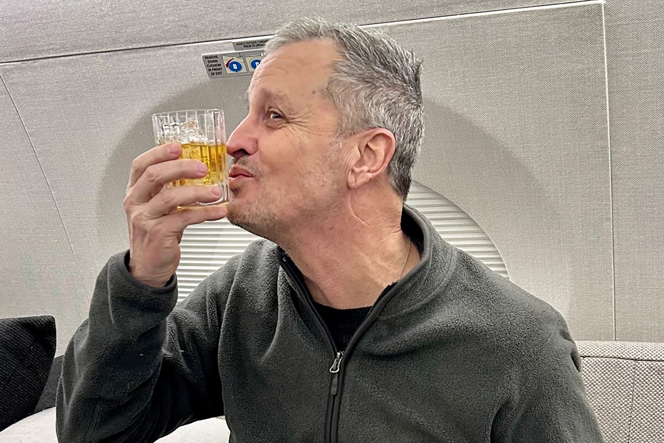 Marc Fogel, an American schoolteacher detained in Russia since August 2021, gestures on an airplane flying him back to the United States after U.S. special envoy Steve Witkoff secured his release February 11, 2025.