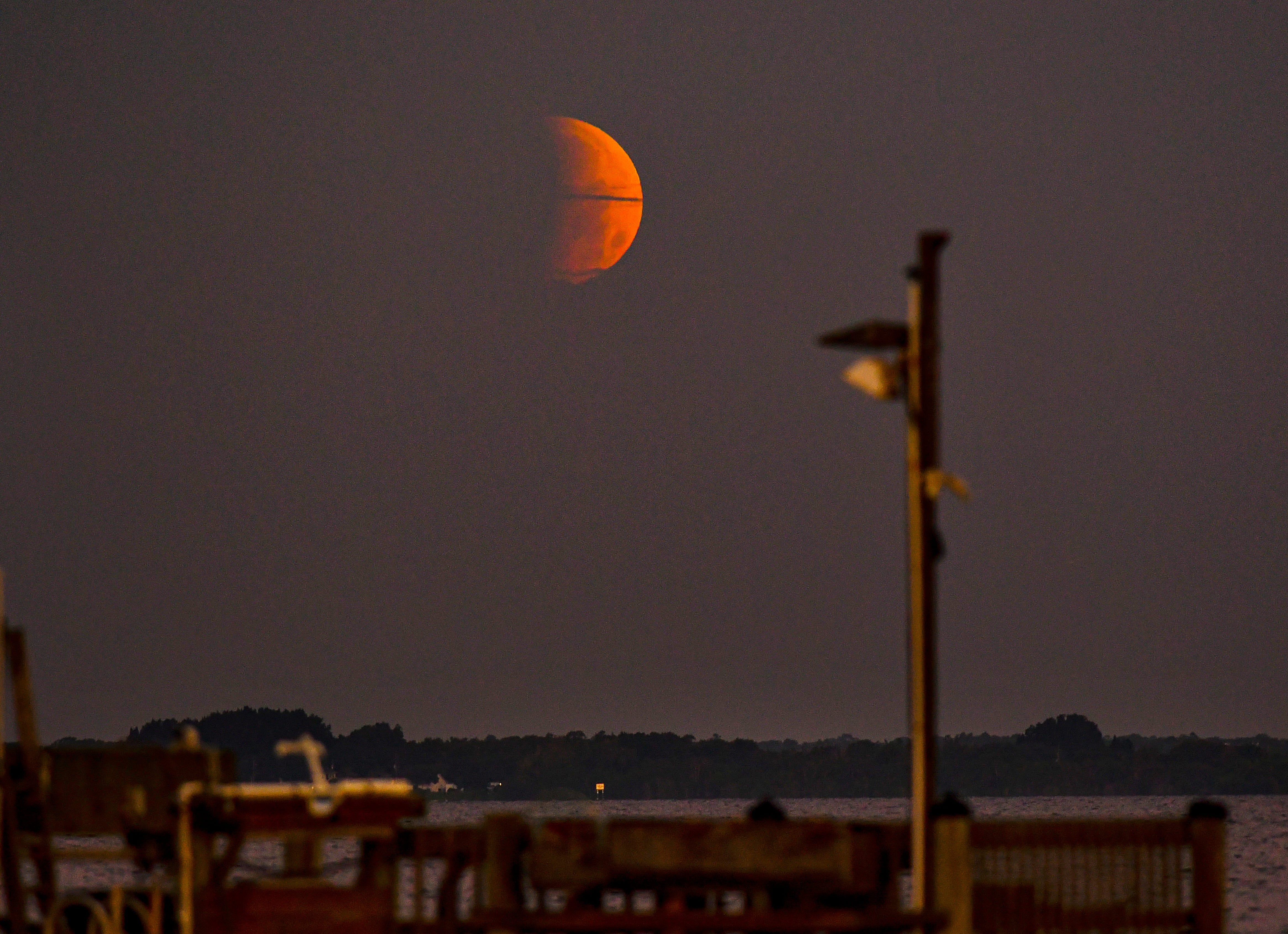 A partial lunar eclipse is visible in 2021 in Florida before the moon disappeared below the horizon at sunrise.