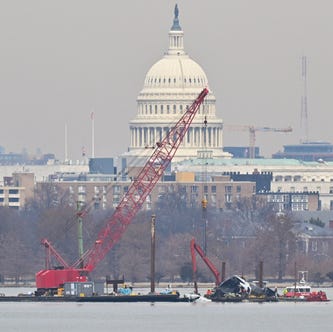 On Feb. 3, 2025, a crane removes airplane wreckage from the Potomac River after American Airlines flight 5342 collided with a U.S. Army military helicopter near Ronald Reagan Washington National Airport in Arlington, Virginia, on Jan. 29.