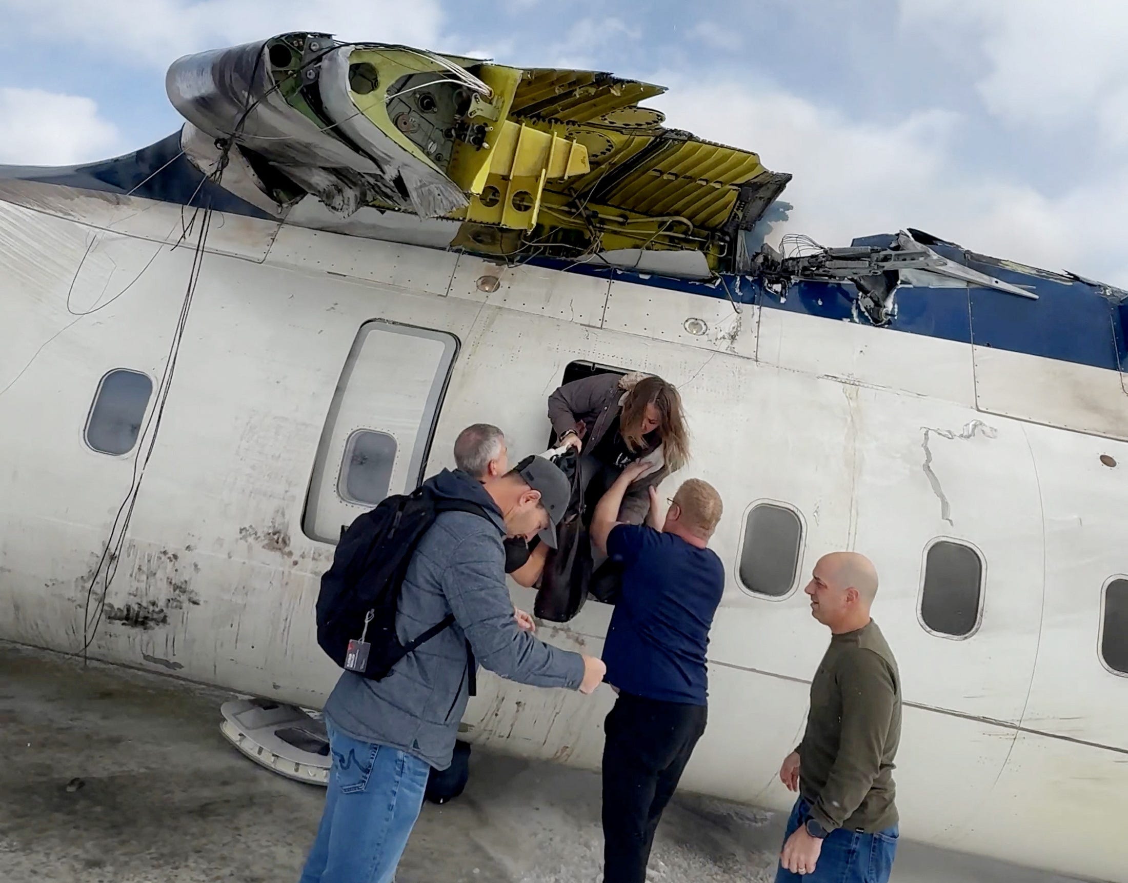 Passengers leave a Delta Air Lines CRJ-900 jet after it crashed on landing at Toronto Pearson International Airport in Mississauga, Ontario, Canada February 17, 2025 in a still image from video.