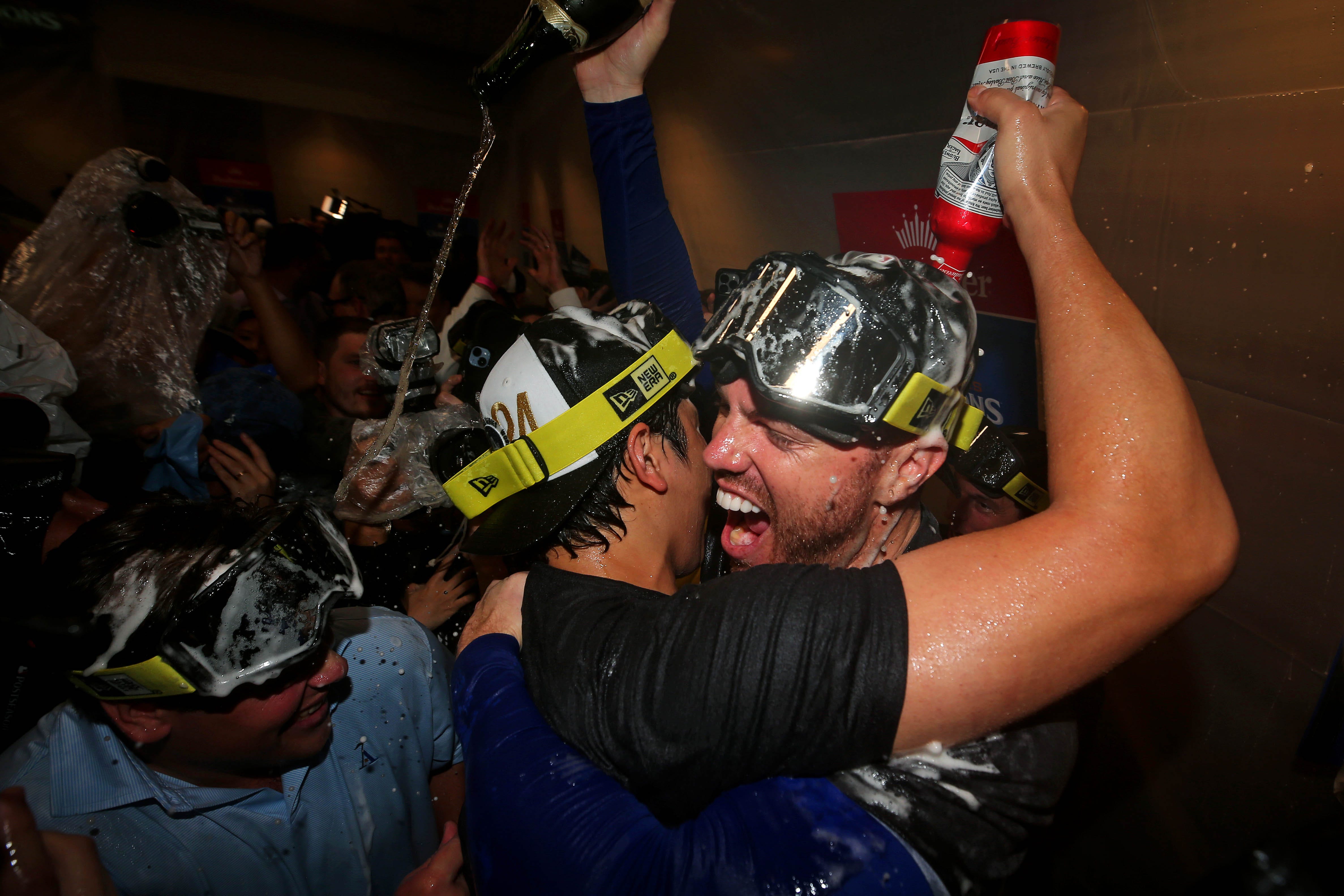 Shohei Ohtani and Freddie Freeman celebrate after winning the World Series.