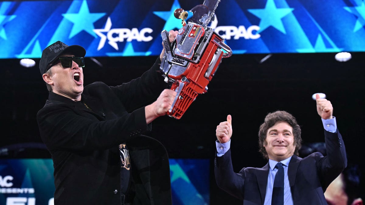 Elon Musk holds a chainsaw as Argentine President Javier Milei cheers during the annual Conservative Political Action Conference outside Washington, D.C., on Feb. 20, 2025.