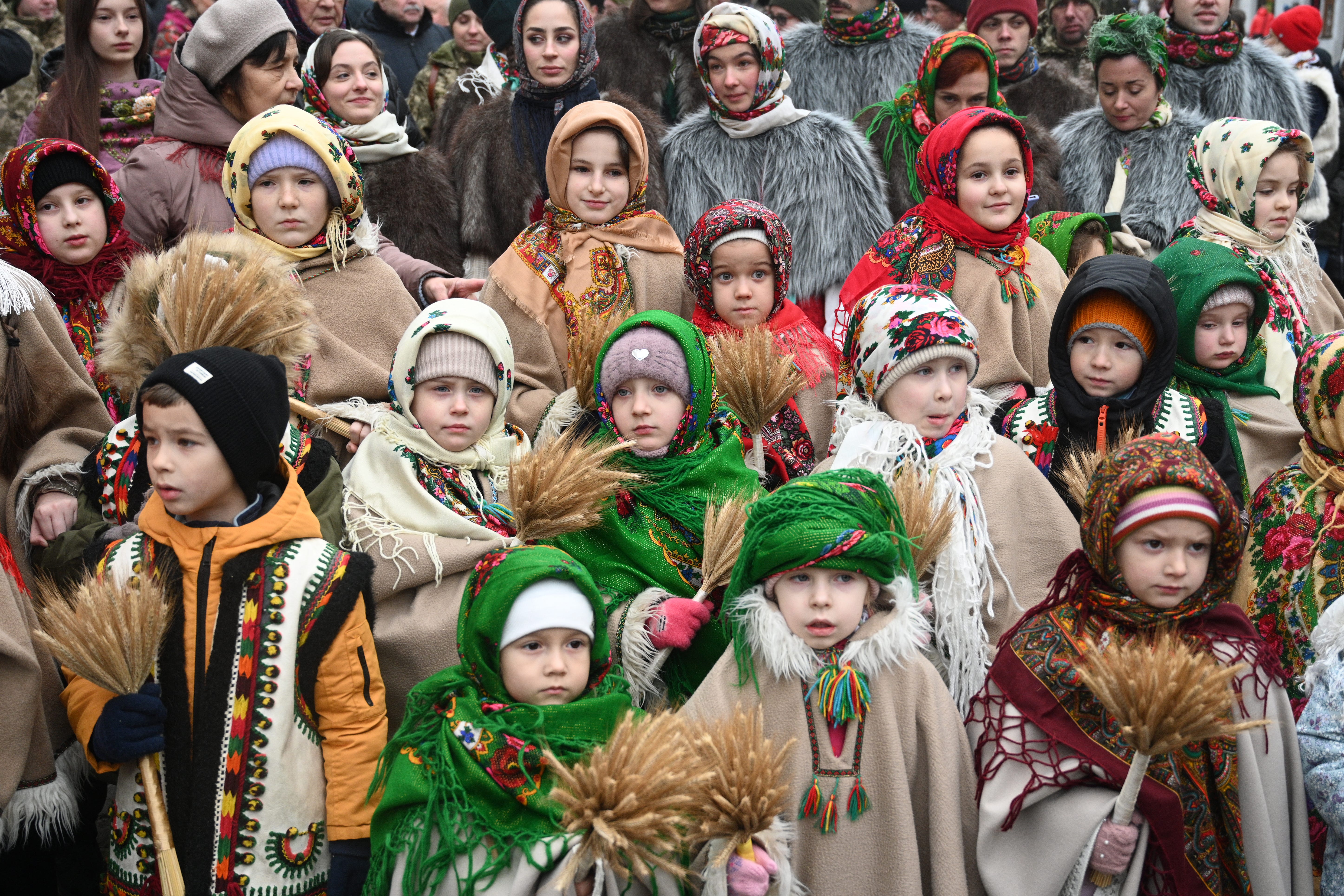 Ukrainian children wearing traditional clothes carry bunches of wheat in a Christmas Eve procession in Lviv in 2024. "Didukh" is a Ukrainian Christmas decoration made of bunches of wheat, symbolizing sacrifice and meaning "spirit of grandfather." Before Russia invaded in 2022, Ukraine ranked among the top global grain exporters, feeding 400 million people worldwide a year.