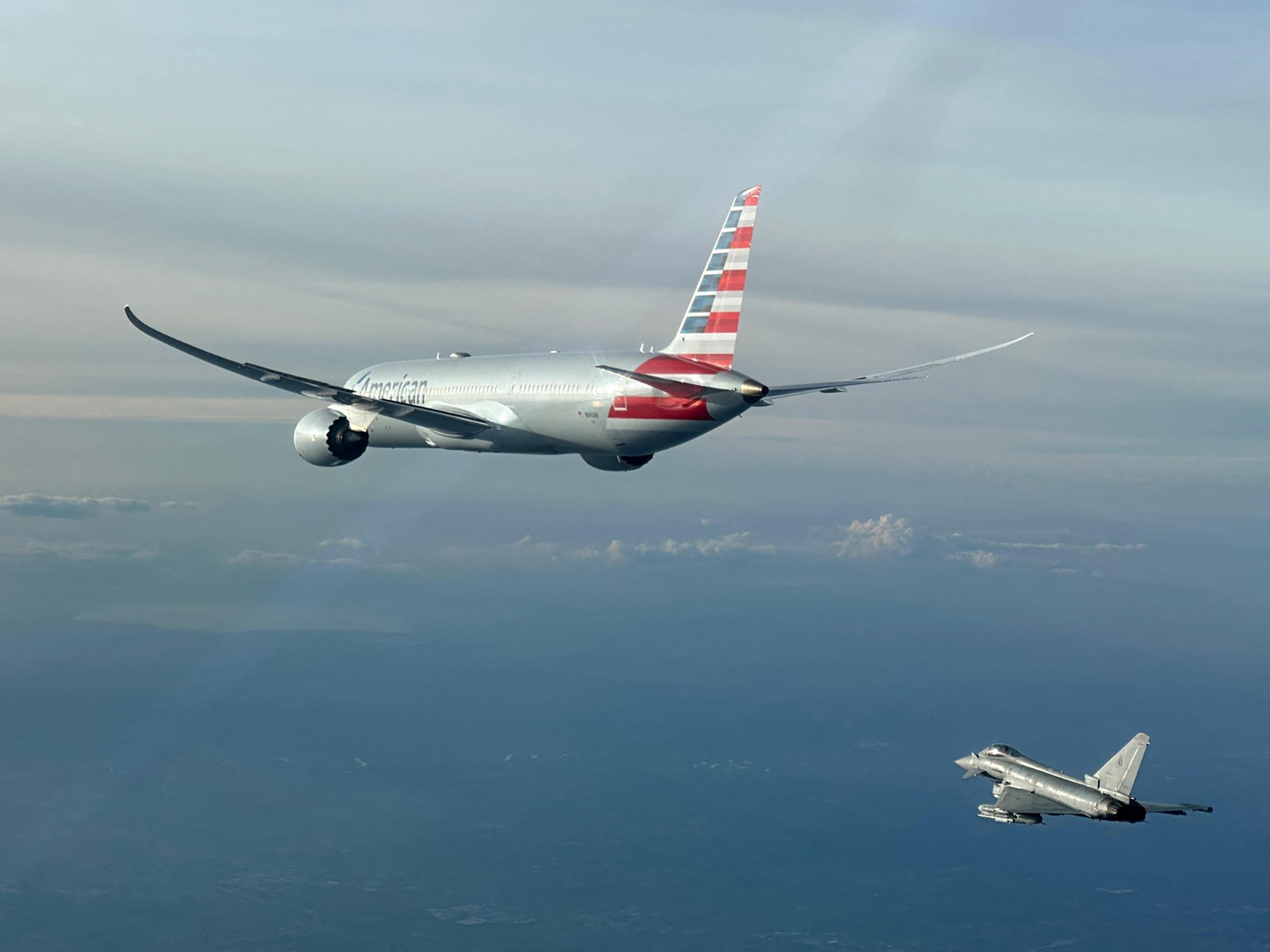 This handout picture taken and released by the Italian Air Force - Aeronautica Militare on Feb. 23, 2025, shows an American Airlines flight escorted by a Eurofighter from the Italian Air Force. An American Airlines flight from New York to New Delhi was diverted to Rome on the afternoon of Feb. 23, 2025, following an "alleged bomb scare," an Italian airport spokesman said. The plane carrying 199 passengers plus crew landed at Rome's Fiumicino airport without   incident, the spokesman told AFP.