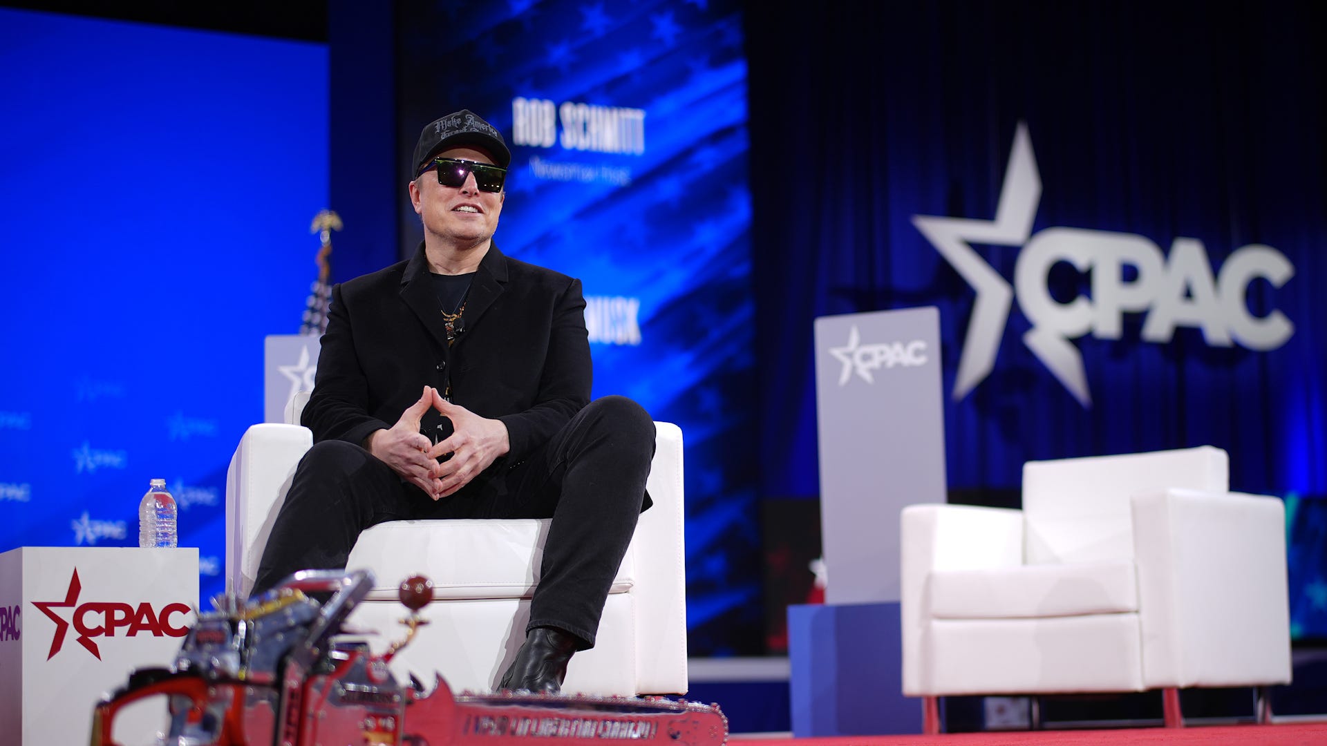 Elon Musk with a chainsaw at his feet at the Conservative Political Action Conference (CPAC) on Feb. 20, 2025, outside Washington, D.C., in Oxon Hill, Md.