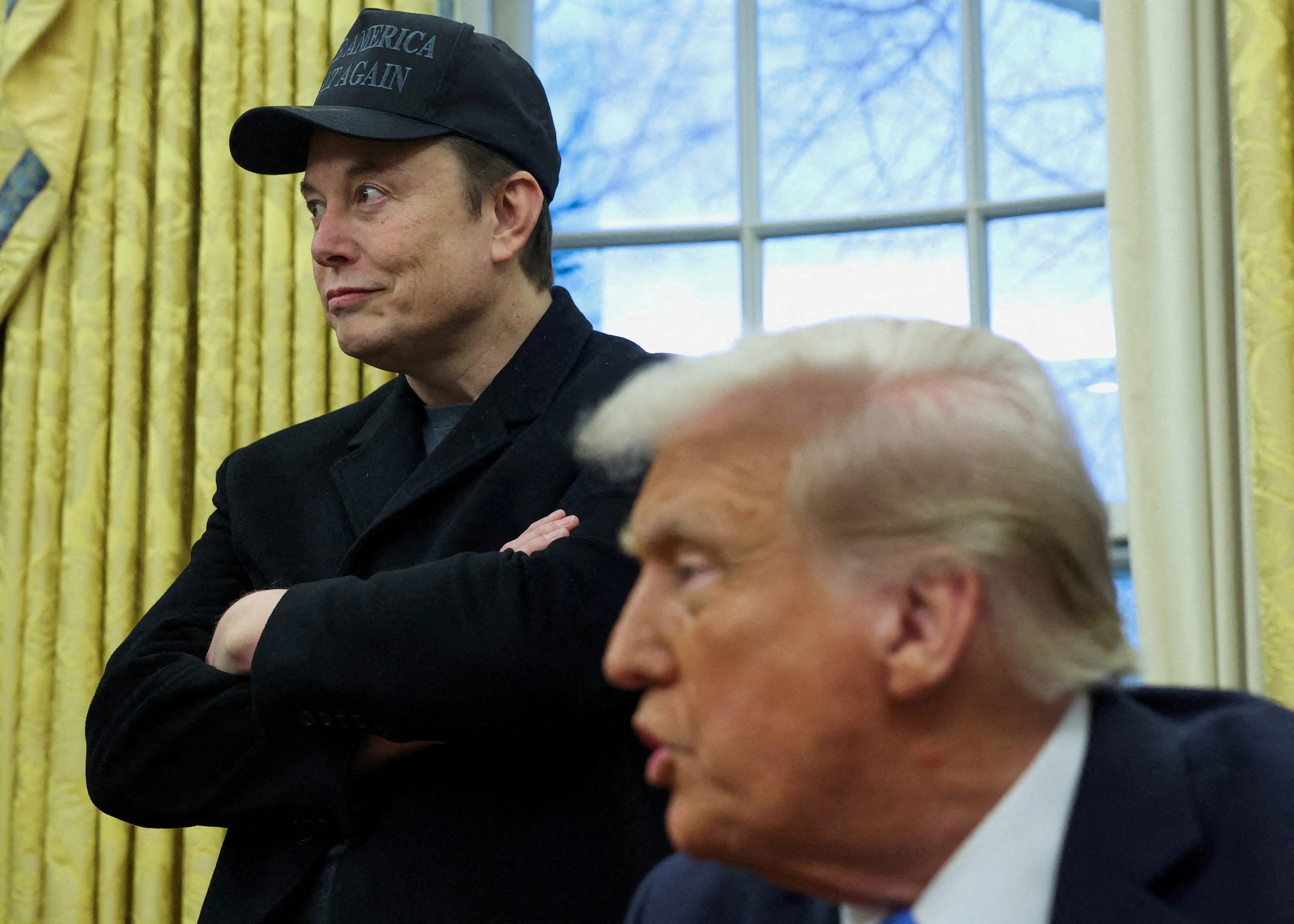 Elon Musk listens to President Donald Trump speak in the Oval Office of the White House in Washington, D.C., on Feb. 11, 2025.