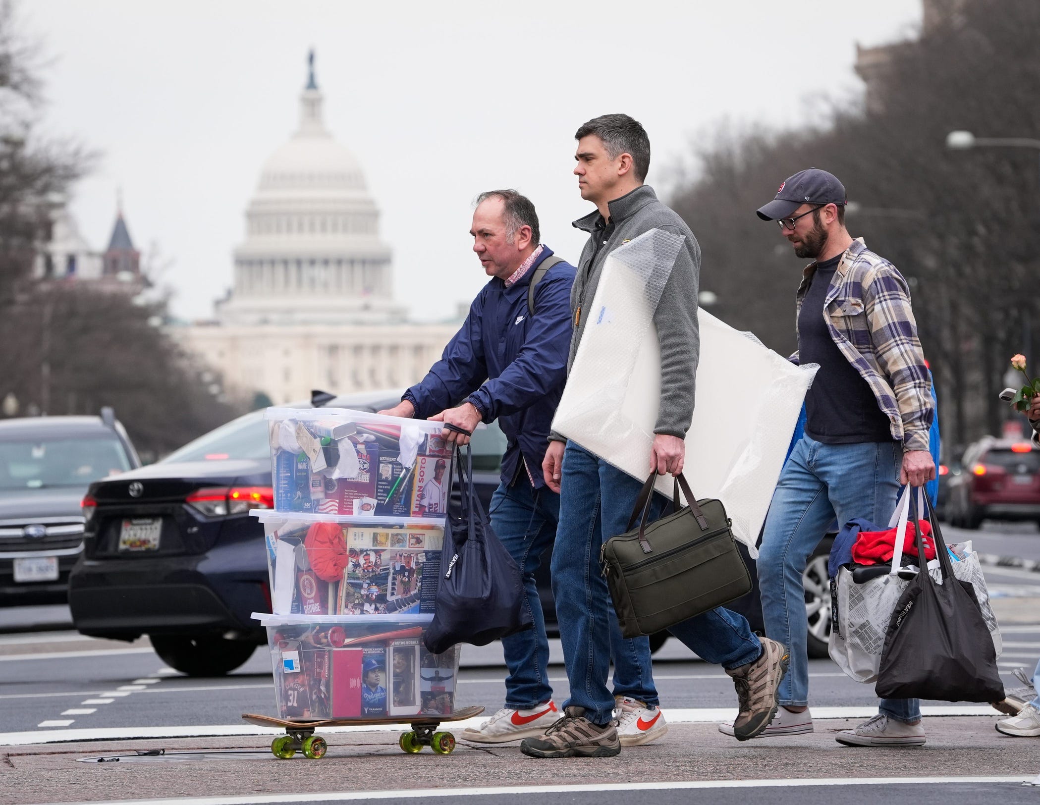 Employees of the Agency for International Development depart with their office belongings on Feb. 27, 2025, from USAID headquarters in Washington, D.C.