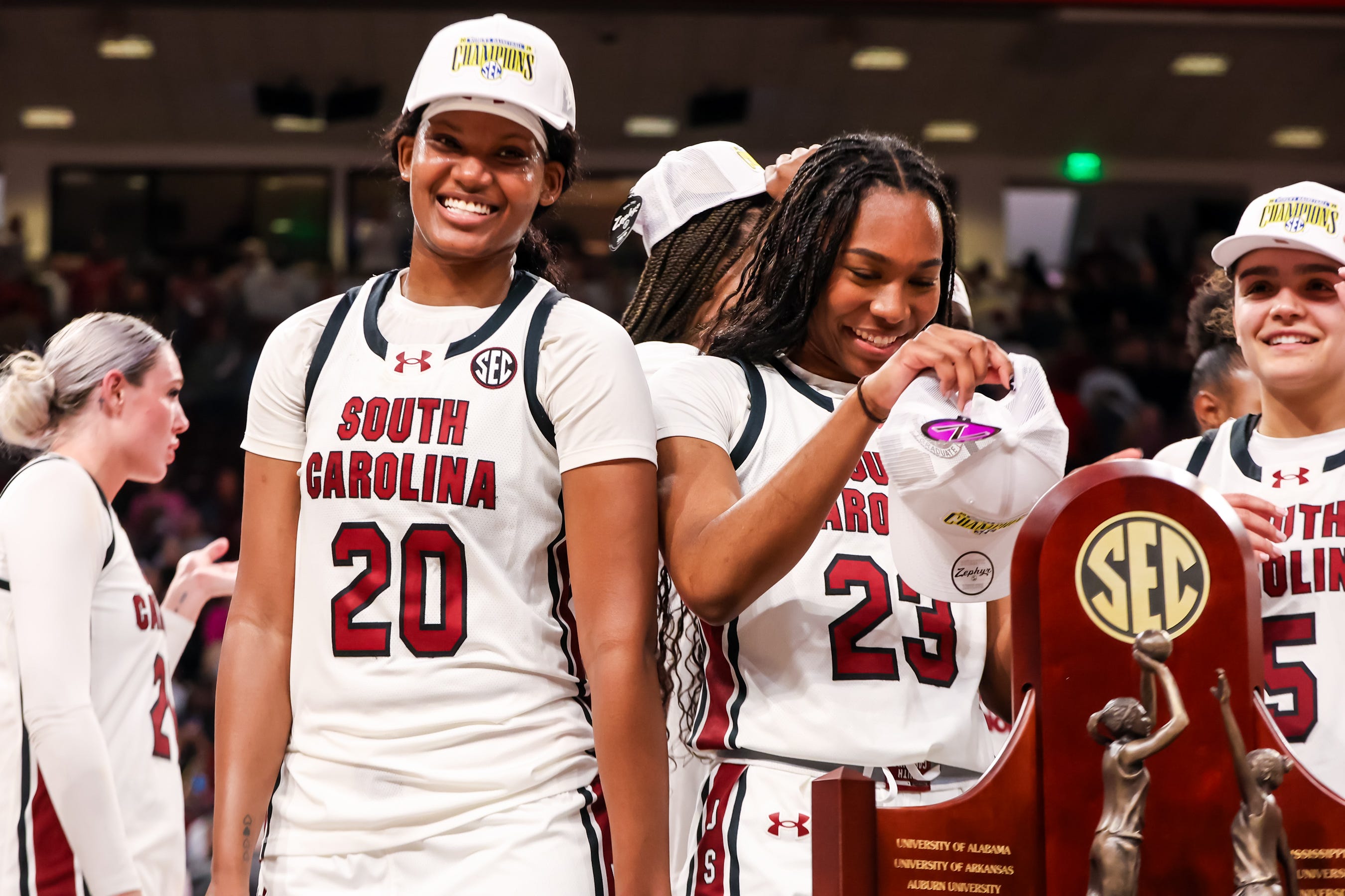 Mar 2, 2025; Columbia, South Carolina, USA; South Carolina Gamecocks forward Sania Feagin (20) and guard Bree Hall (23) try on SEC Championship hats after defeating the Kentucky Wildcats at Colonial Life Arena. Mandatory Credit: Jeff Blake-Imagn Images