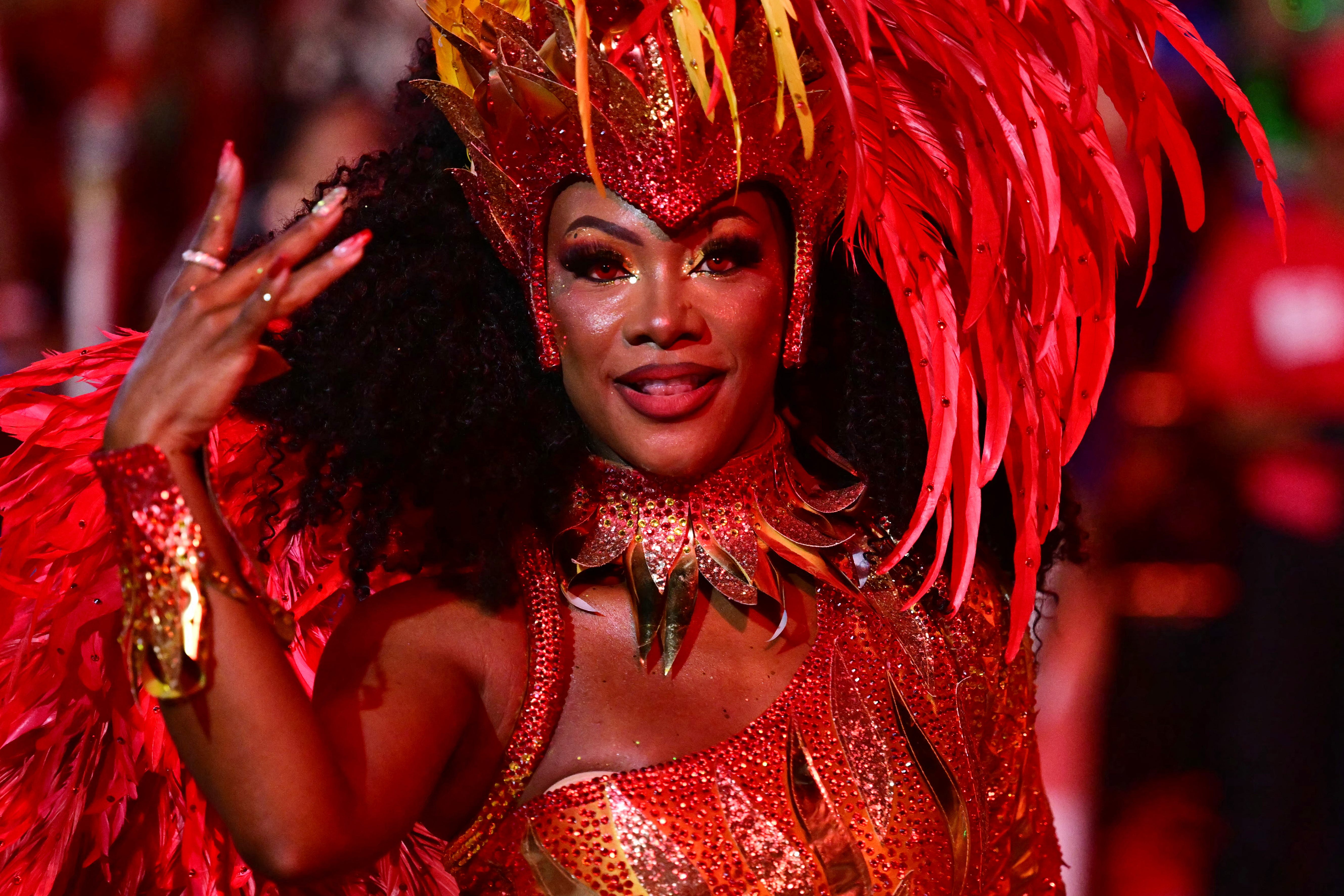 A reveller of the Viradouro samba school gestures as she performs during the first night of carnival at the Marques de Sapucai Sambadrome in Rio de Janeiro, Brazil on March 3, 2025.