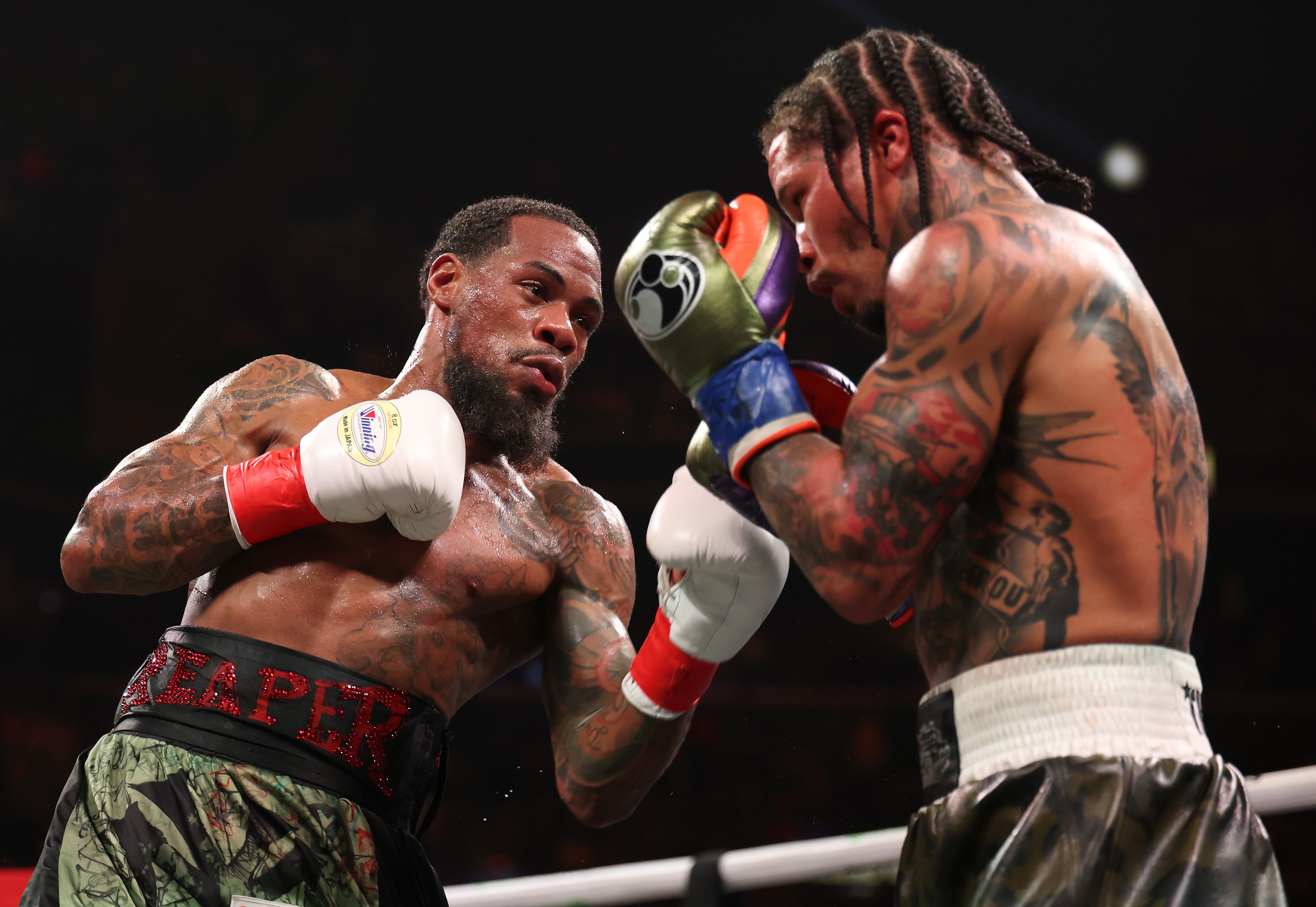 Lamont Roach Jr. punches Gervonta Davis during their Saturday's bout.
