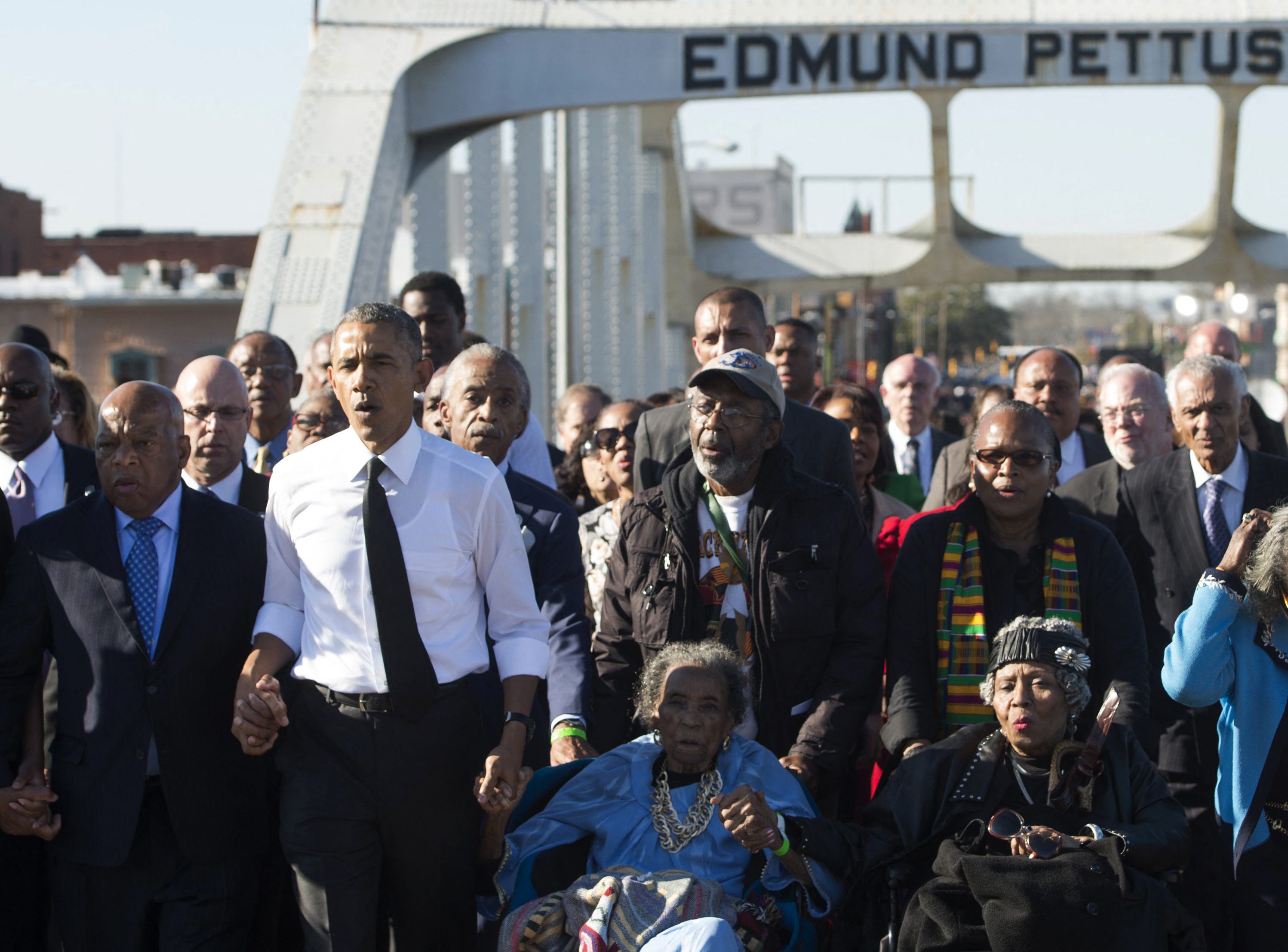 President Barack Obama (2L) and Representative John Lewis (L), Democrat of Georgia and one of the original marchers, sing as they lead a walk across the Edmund Pettus Bridge to mark the 50th Anniversary of the Selma to Montgomery civil rights marches on March 7, 2015. President Barack Obama rallied a new generation of Americans to the spirit of the civil rights struggle, warning their march for freedom "is not yet finished." In a forceful speech in   Selma, Ala. on the 50th anniversary of the brutal repression of a peaceful protest, America's first black president denounced new attempts to restrict voting rights.