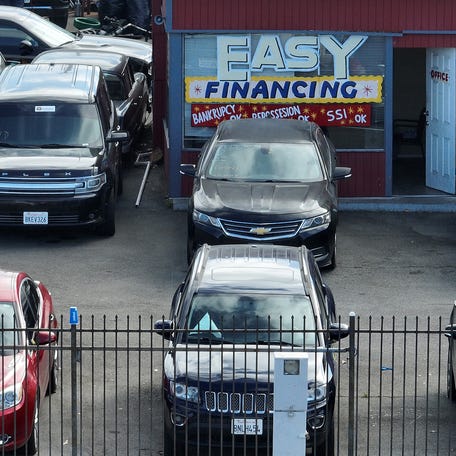 SAN PABLO, CALIFORNIA - SEPTEMBER 06: An advertisement of easy financing is posted on the front window of a used car lot on September 06, 2023 in San Pablo, California. Credit monitoring agencies are seeing a rise in defaults of credit card and auto loan payments as inflation continues to squeeze the pocketbooks of many Americans. According to credit agency Equifax, credit card delinquencies are at 3.8% default rate and car loans are at 3.6%.