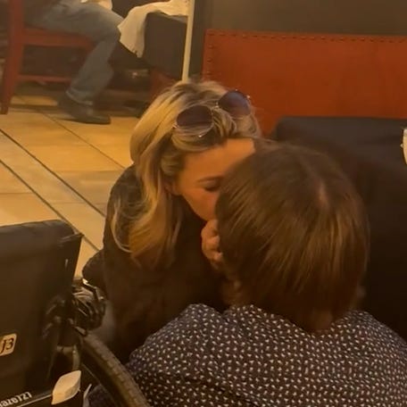 Paraplegic Michael Maze gets out of his wheelchair to propose to his girlfriend Trinity Brooks at their favorite restaurant in Tulare, California.