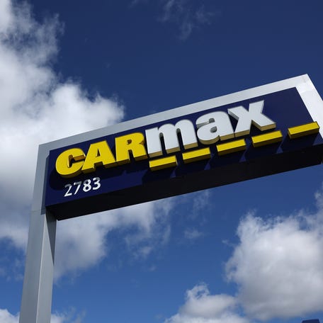 A sign is posted in front of a CarMax dealership on April 11, 2023 in California.