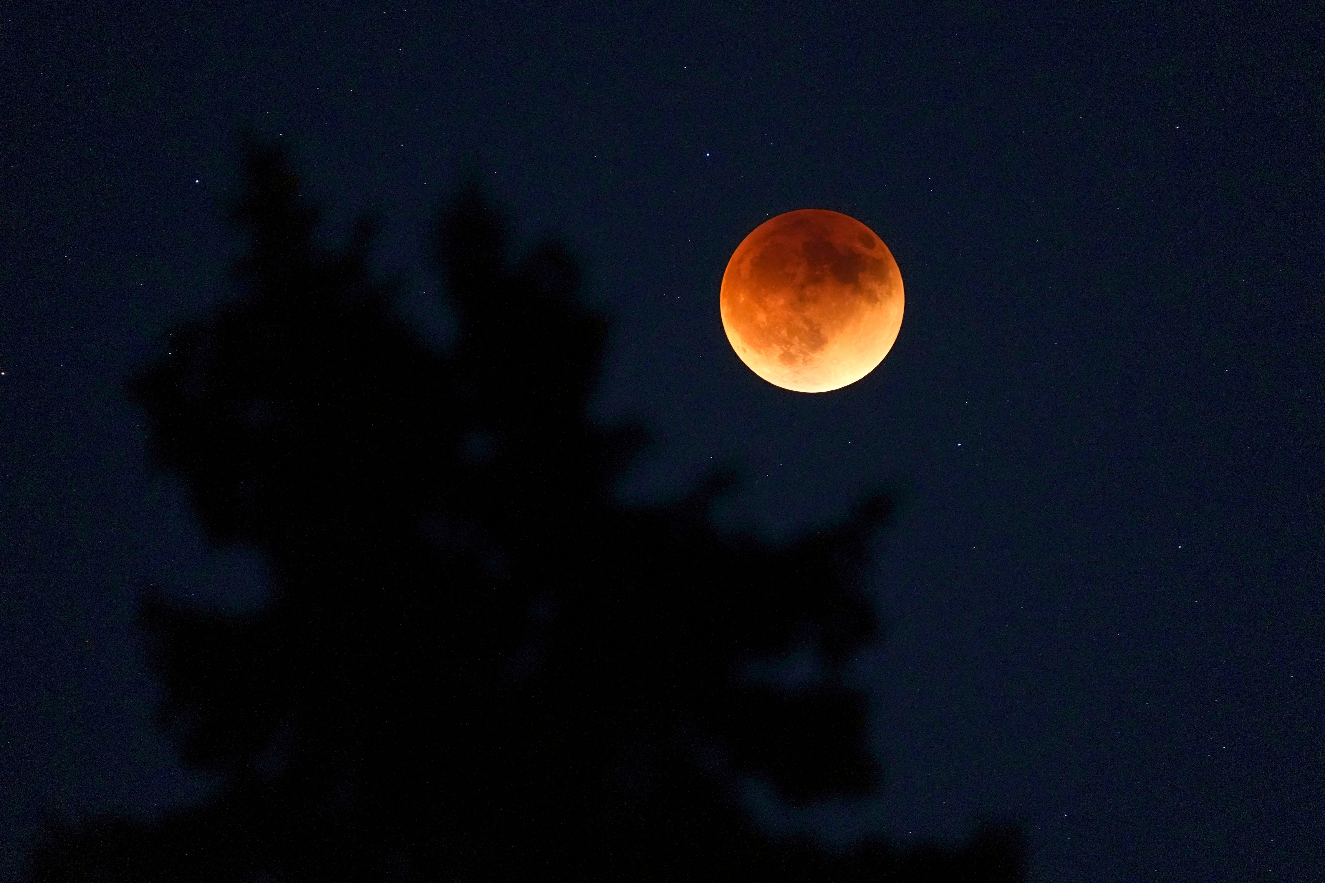 A total lunar eclipse is seen near Milwaukee on Sunday, May 15, 2022. Lunar eclipses happen when the Earth passes between the sun and the moon.