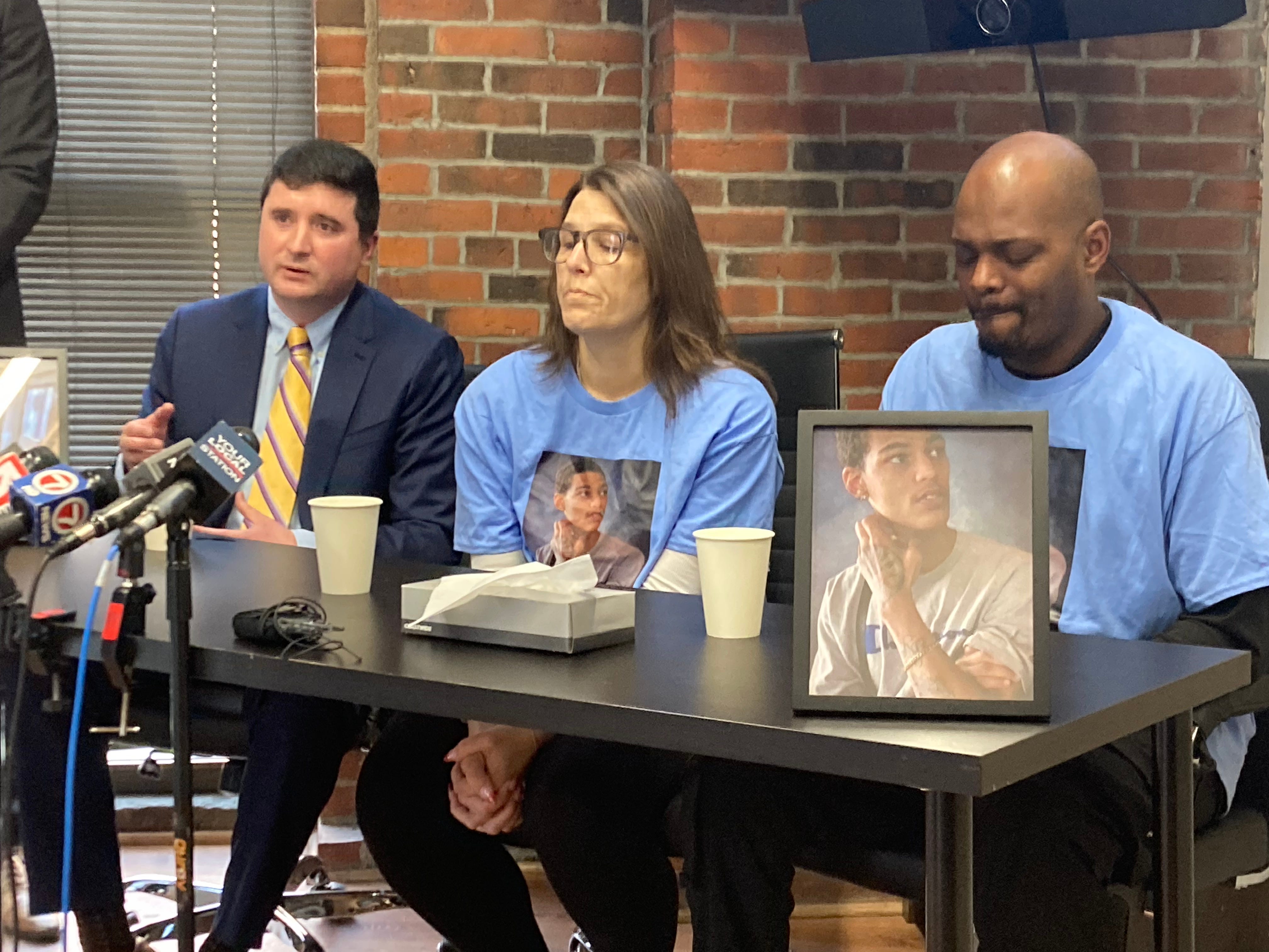 At the Boston firm Michael Kelly Injury Lawyers, from left, lawyer John McCarthy, the victim's mother, Stacey Houston, and the victim's father, Delmahr Wright.