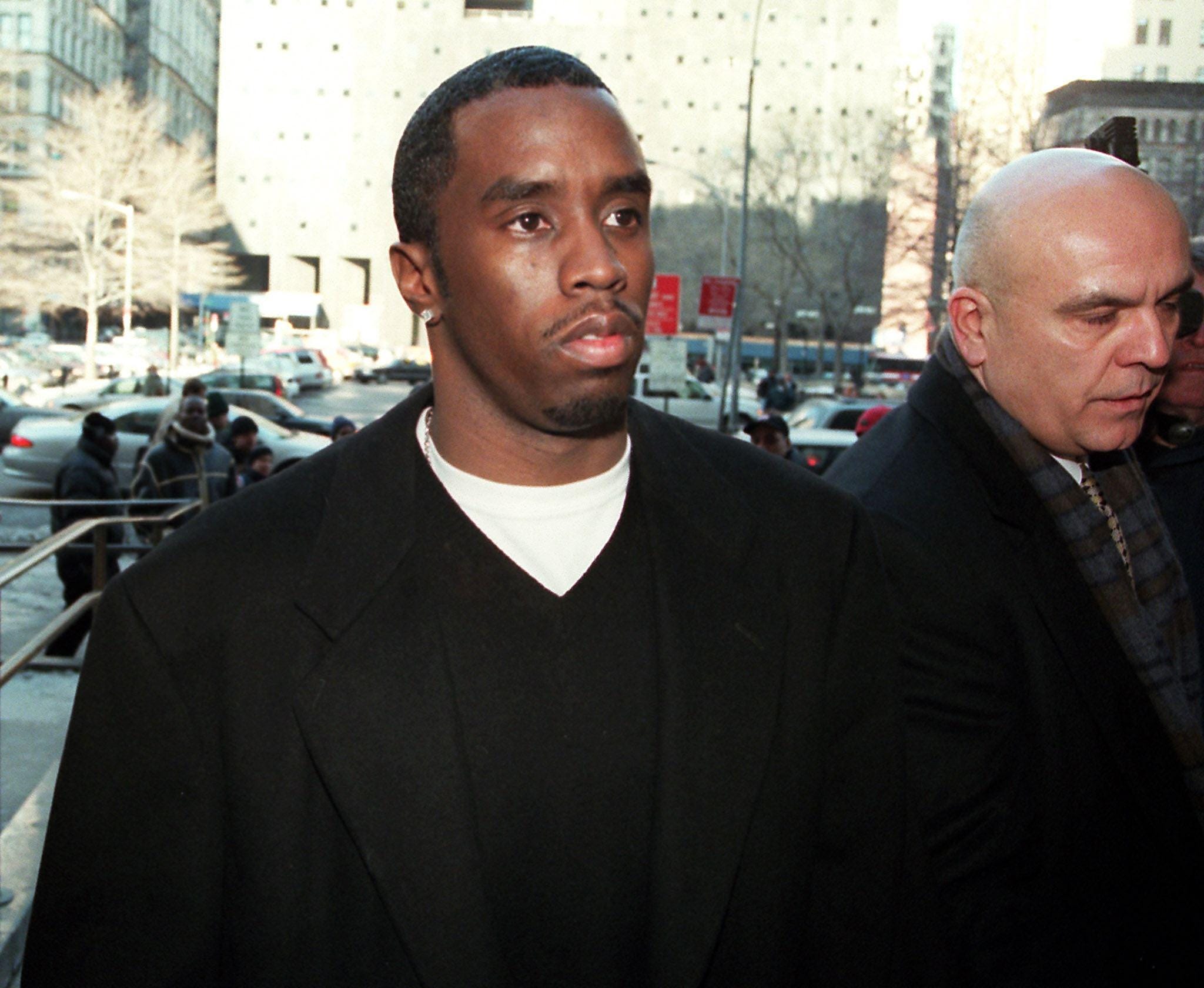 NEW YORK, UNITED STATES: Rap star Sean "Puff Daddy" Combs enters court in New York 07 February, 2000. Combs had an arraignment hearing on weapon possession charges in connection with a shooting at a New York nightclub in December.   AFP PHOTO/Doug KANTER (Photo credit should read DOUG KANTER/AFP via Getty Images)