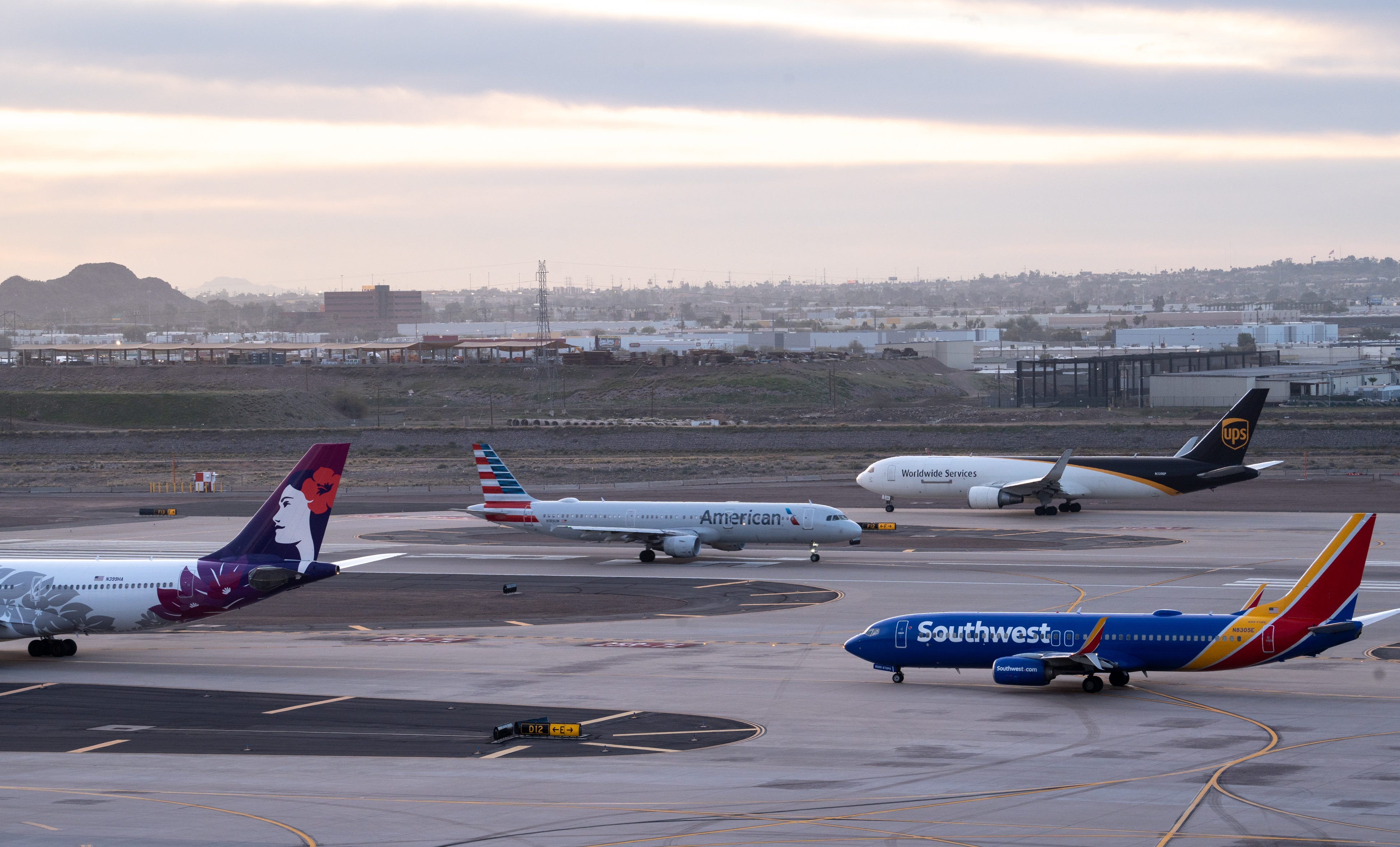 Planes wait to takeoff on Jan. 11, 2023, at Phoenix Sky Harbor International Airport.