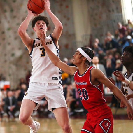 Our Lady of Lourdes' Zach Hart takes a jump shot over Binghamton's Zubayr Griffin during the Class AA boys basketball regional championship on March 15 2025.