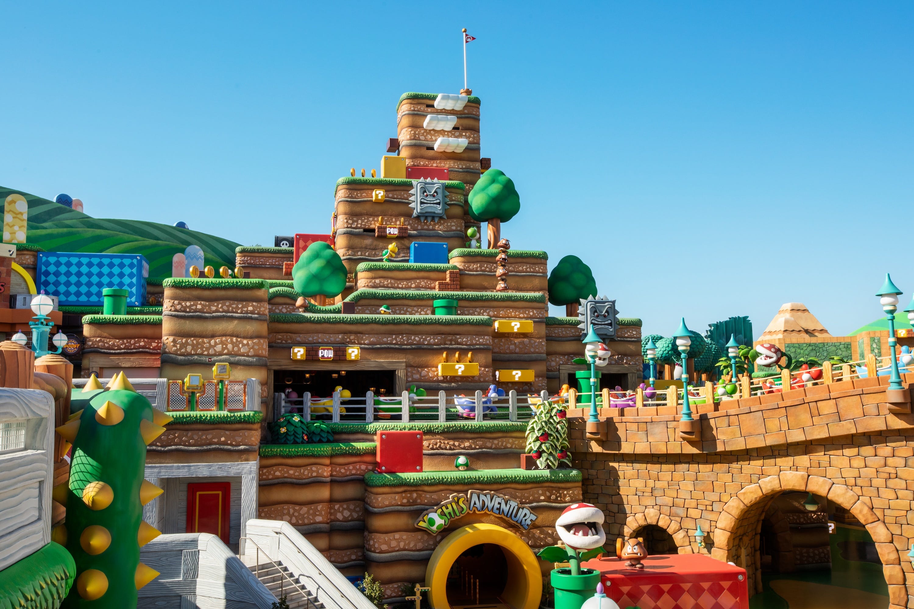 SUPER NINTENDO WORLD is a colorful portal with the iconic green pipe entrance.